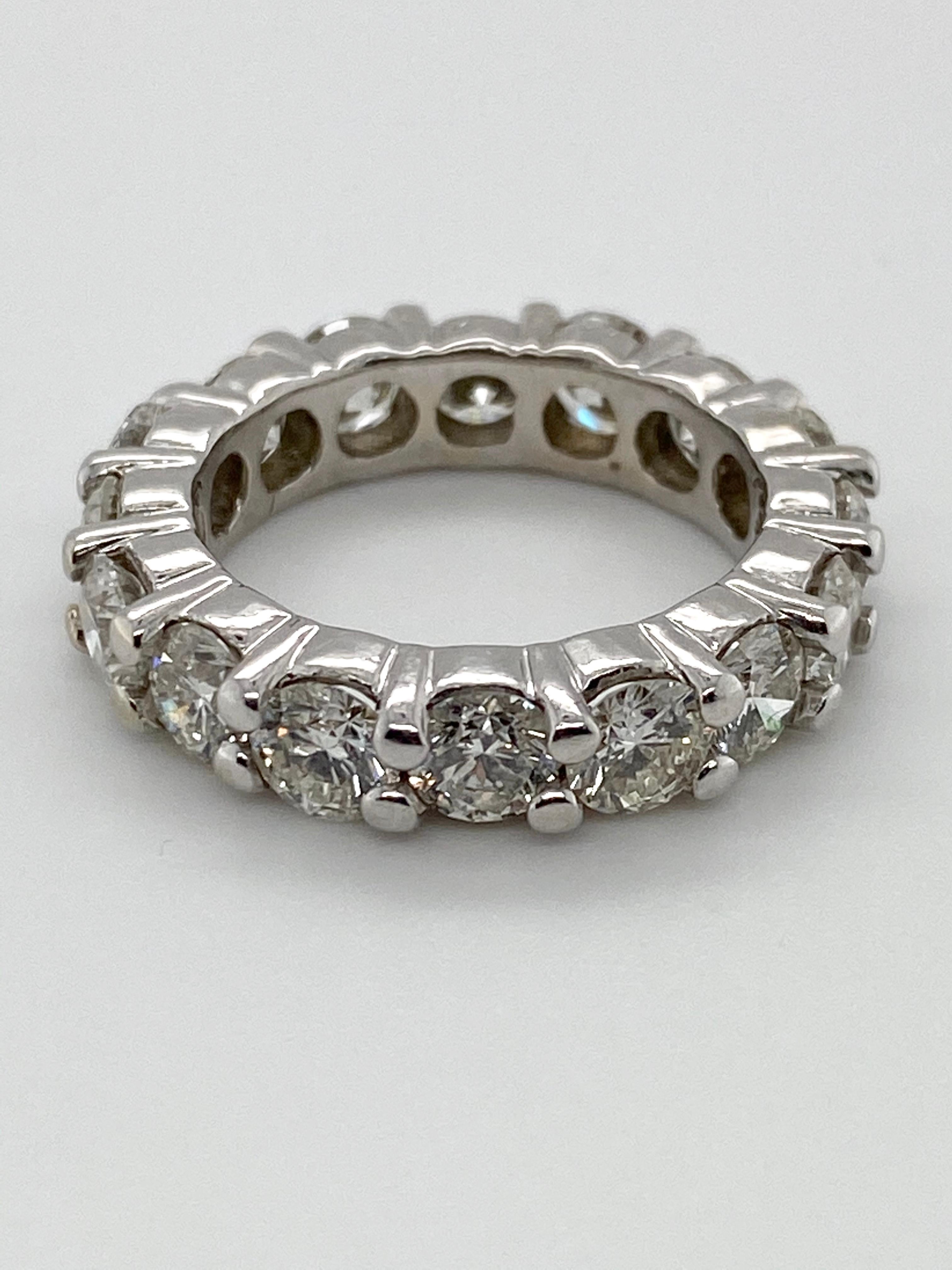 A classic white gold eternity band set with 16 round brilliant diamonds of approximately 5cts total weight.  This band was designed with consecutive diamonds set at slightly differing heights, creating an interesting visual contour when viewed from