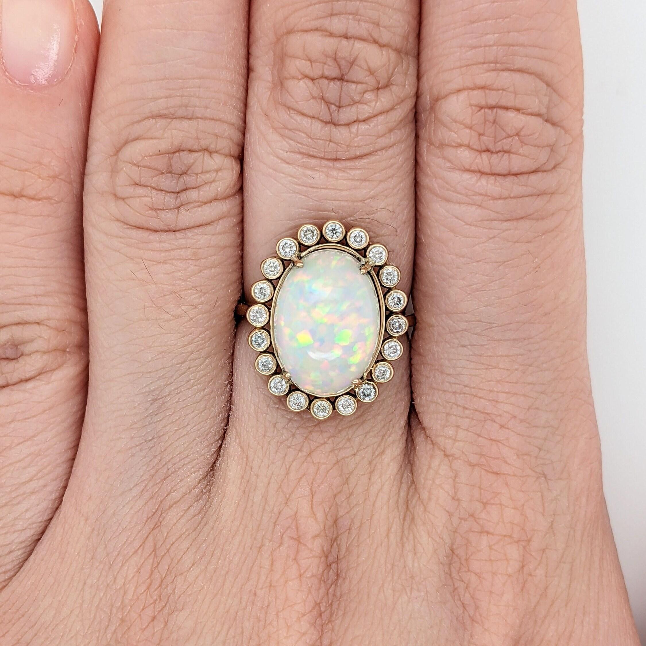 Celebrate in style with this stunning 4.98ct opal ring! Crafted from solid 14k yellow gold & accented with natural diamond accents, this eye-catching Oval ring will make a statement. Get ready to turn heads in an instant with this vintage-style gold