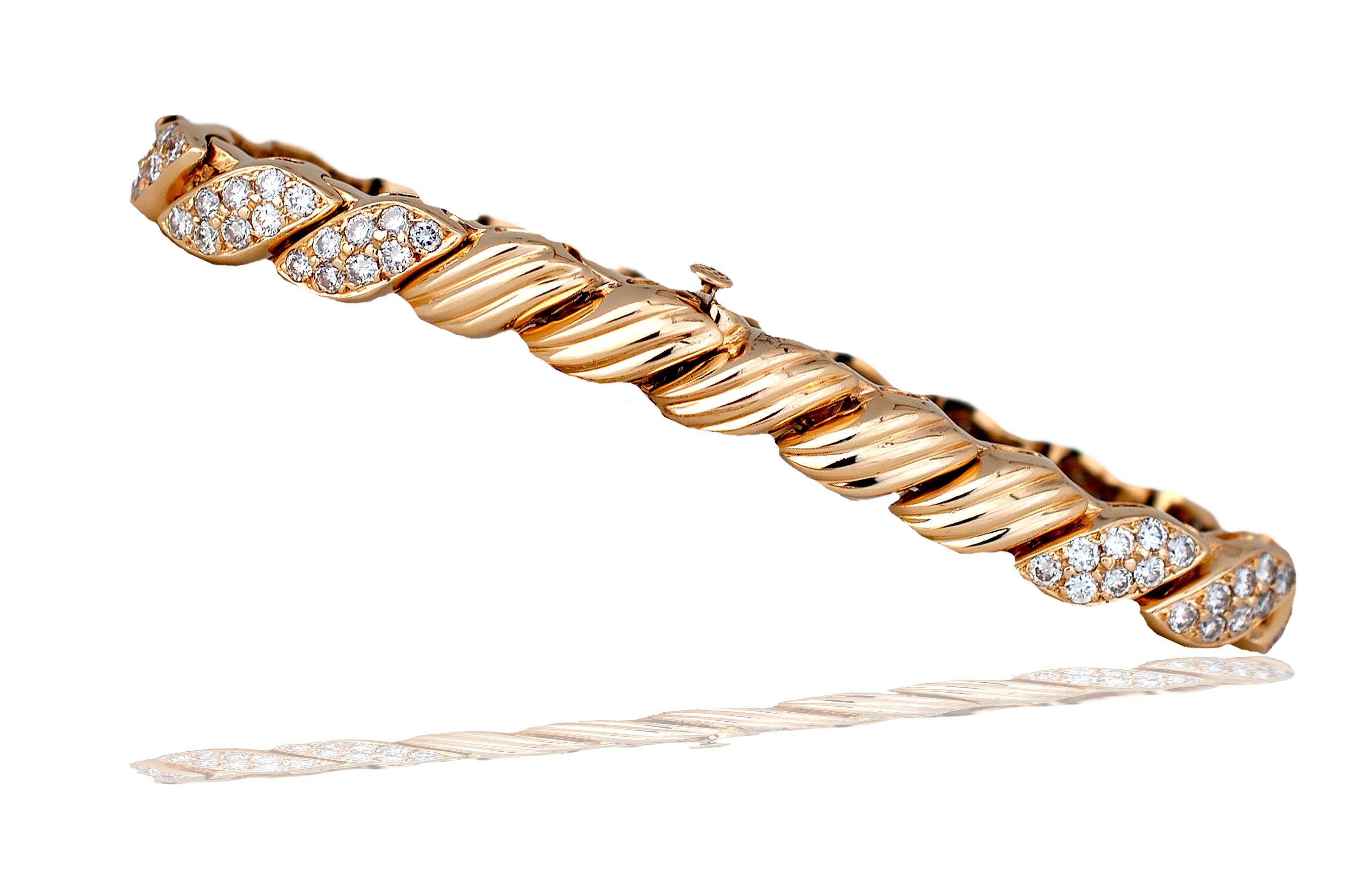 This stunning bracelet has a classic look and gives the wearer a bright appearance when seen in the light.  The bracelet is cast from 14k yellow gold  and weighs 29.2 grams.  The bracelet has stations of nine round brilliant diamonds mounted in