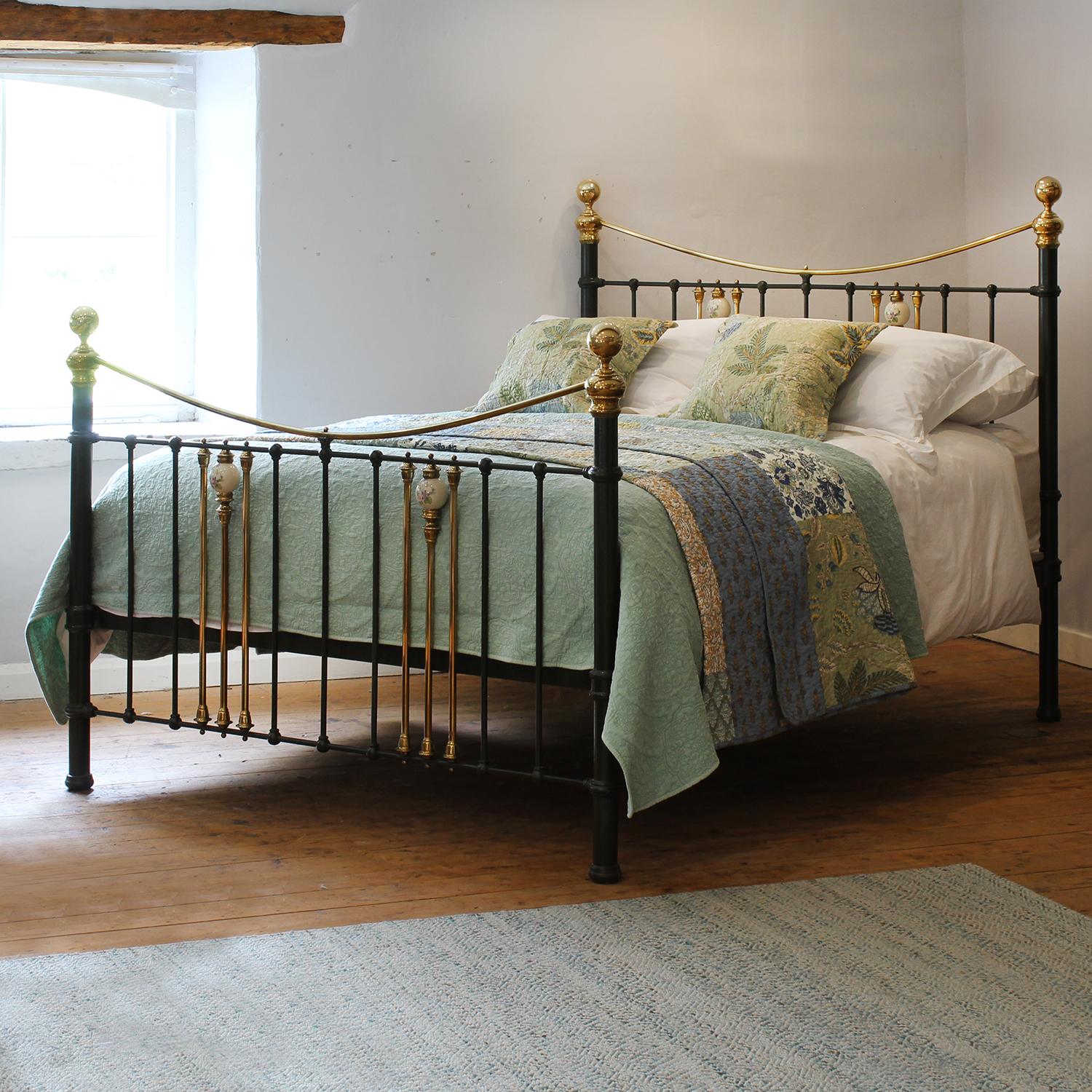 Antique Olive Green Metal Bed with Golden Brass Accents and Floral Ceramic Finials

Painted in a rich olive green, this sturdy antique metal bed exudes character and sophistication, while the graceful curved brass top rails and ornate detailing