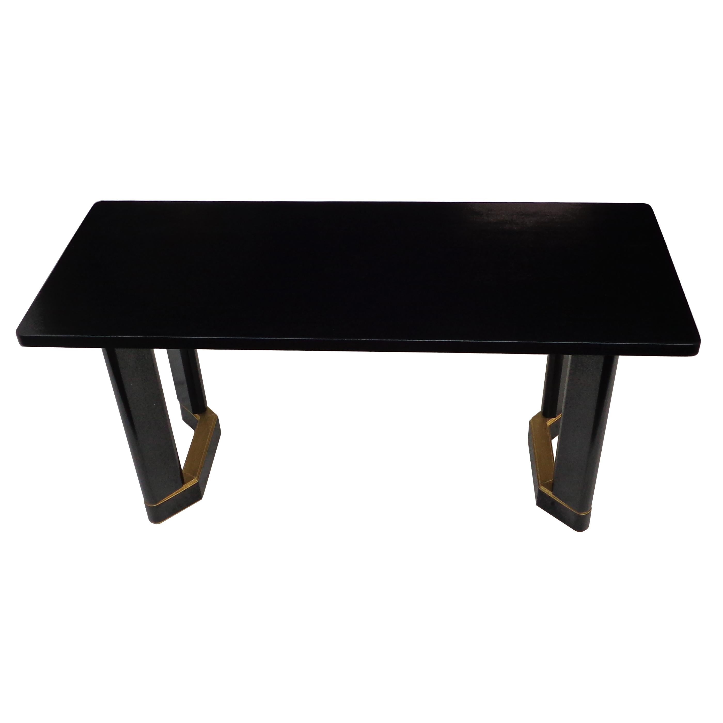 Art Deco style writing or console table

Simple and elegant ebonized table with gold leaf details on pedestal bases. 5Ft.

 
