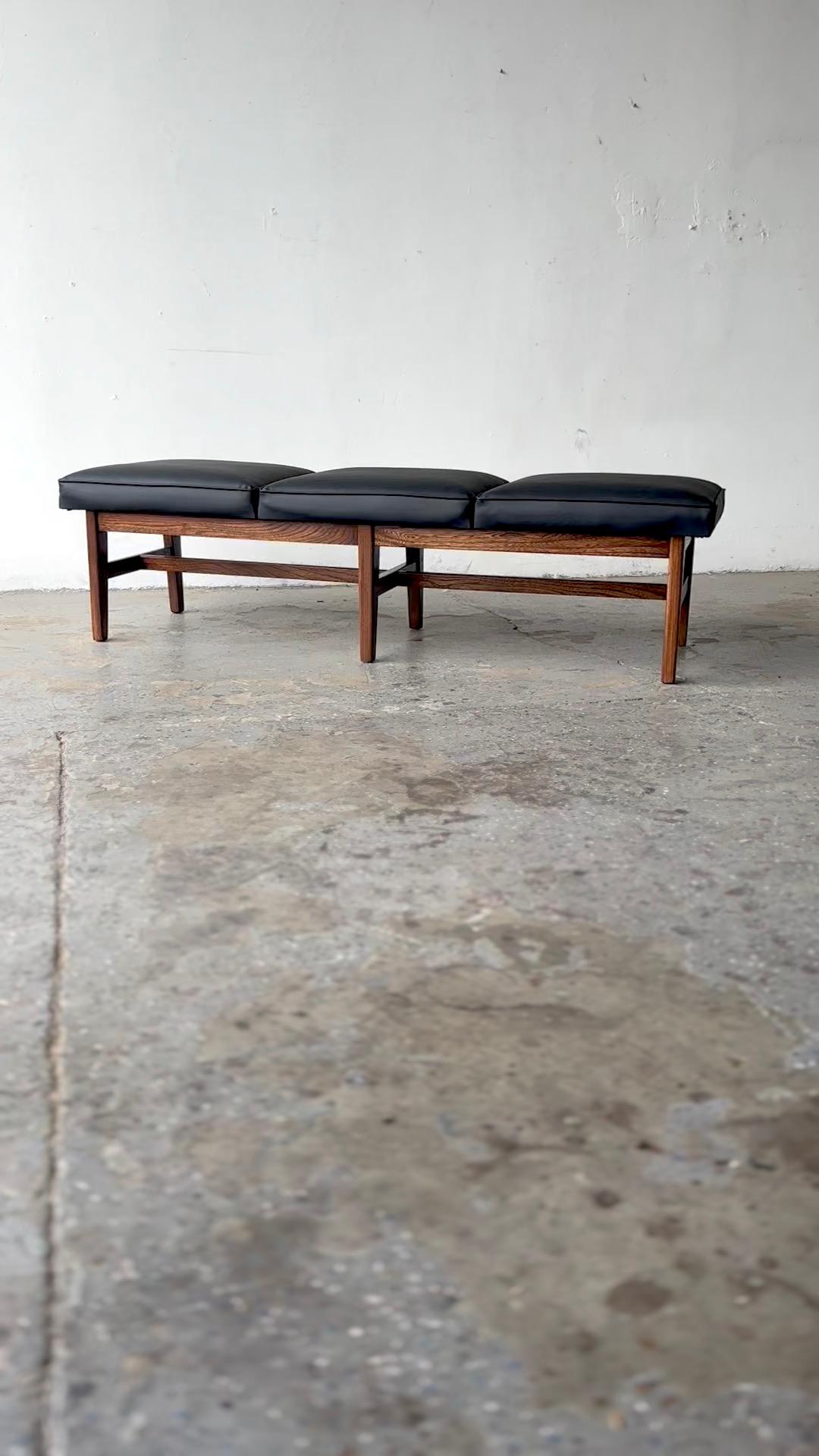Jen Risom Style Mid Century Modern  3-Seat Cushion Bench 
Really cool and true MCM  era bench. 
C.1950’s  3-seat bench  with New  leatherette upholstery over solid  walnut base.
Condition: Professionally  refinished and restored

Measurements 63