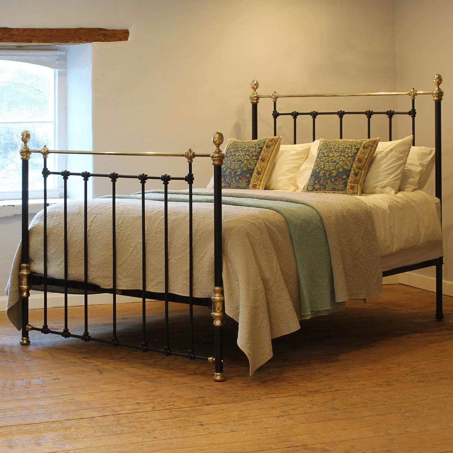 A superb cast iron antique bed finished in black with simple castings, decorative brass fittings and oval shaped knobs.

This bed accepts a UK king size or US queen size (5ft, 60in or 150cm wide) base and mattress set.

The price includes a standard