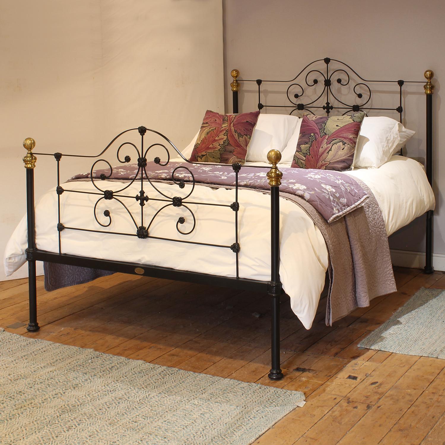 A superb cast iron antique bed finished in black with decorative scroll design and daisy castings, and brass knobs.

This bed accepts a UK king size or US queen size (5ft, 60in or 150cm wide) base and mattress set.

The price includes a standard