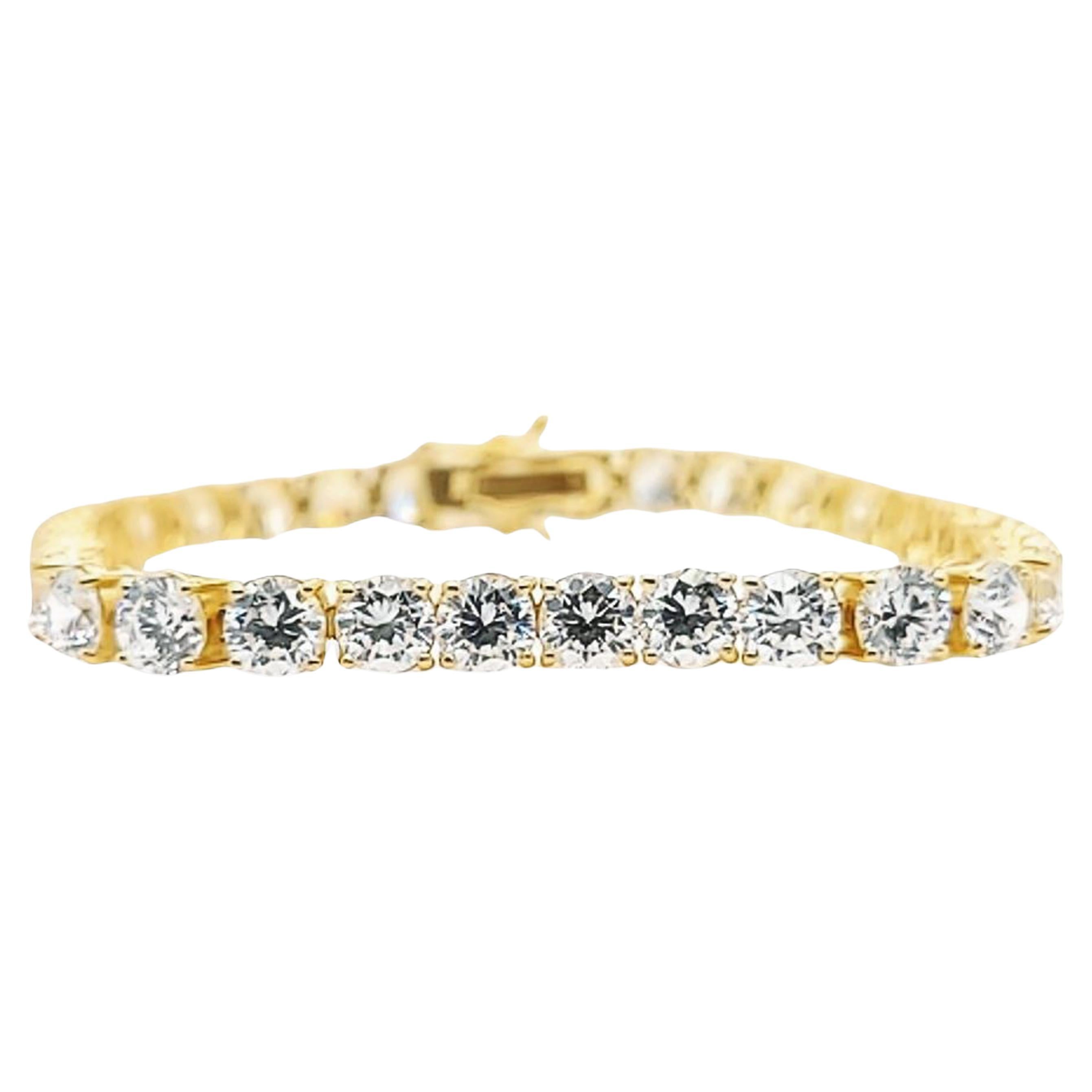 14 Karat Yellow Gold Tennis Bracelet Featuring 5mm Cubic Zirconia. 7 Inches Long with Hidden Box Clasp and Double Figure 8 Safety. Finished Weight is 16.5 Grams.