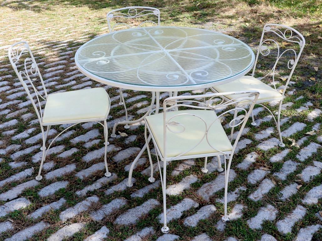 Garden, Patio Dinette set includes a circular glass top table ( 43 inch diameter x 29 inch height) with original textured glass top and 4 side chairs each 32.5 H x 32.5 D x 17 W x Seat H 18. All pieces are in very good, original condition, clean and