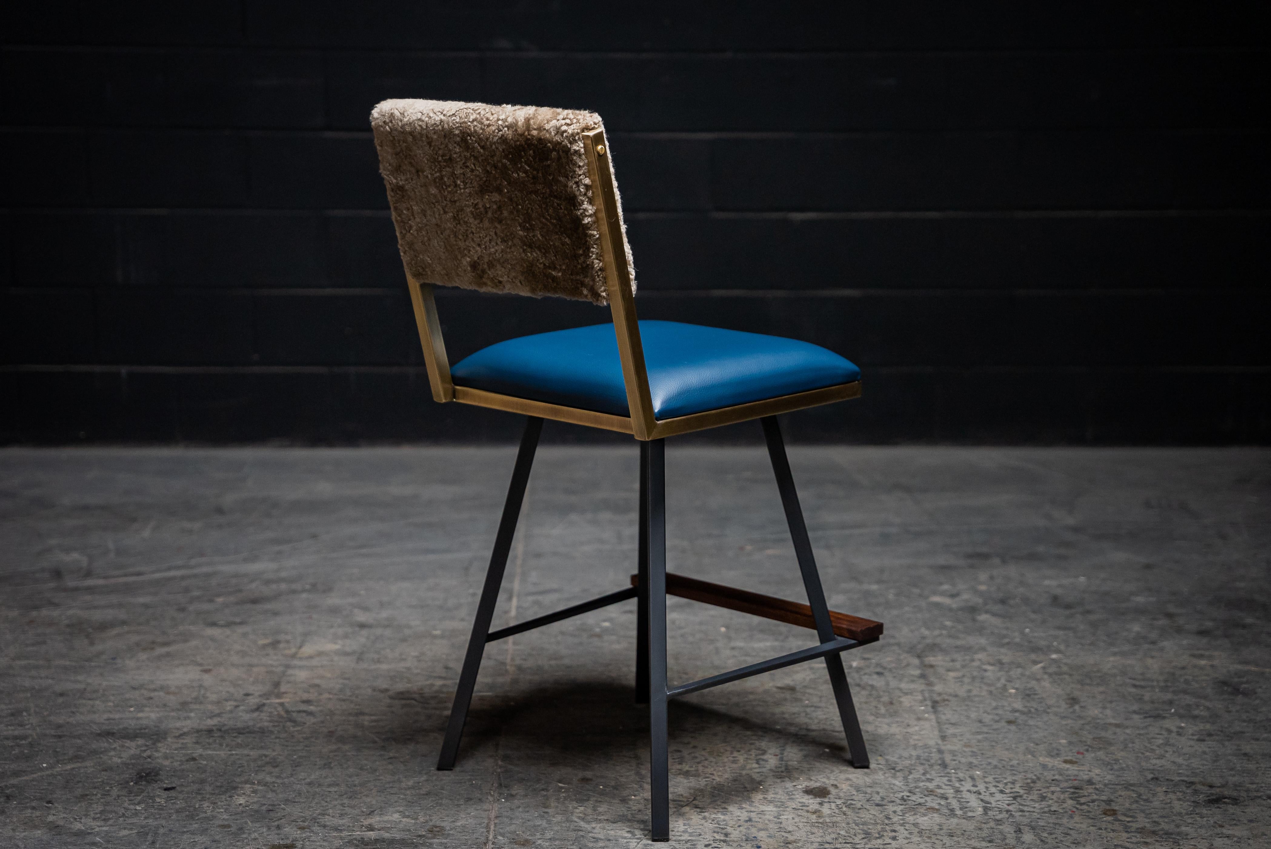 The Shaker swivel counter chair is made to order. This contemporary / modern swivel armchair is available in a large variety of genuine leathers, vinyls, Shearlings, cowhides & also offered in COM & COL. Inspired by the boarding ladder steps of an