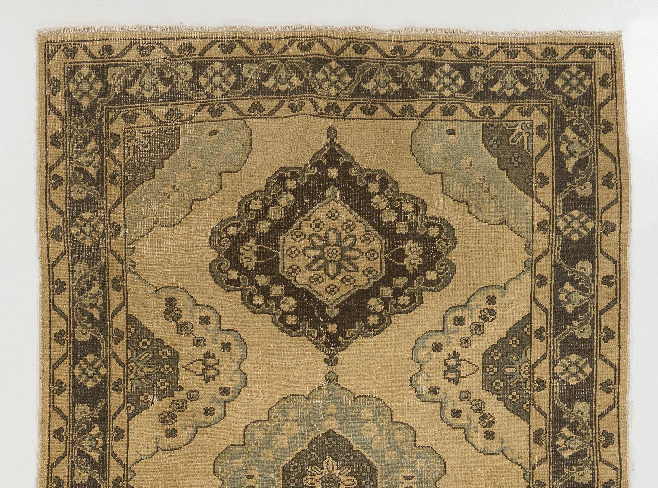A vintage Turkish runner rug. It was hand-knotted in the 1960s with low wool on cotton foundation and features a multiple geometric medallion design. It is in very good condition, professionally-washed, sturdy and suitable for areas with high foot