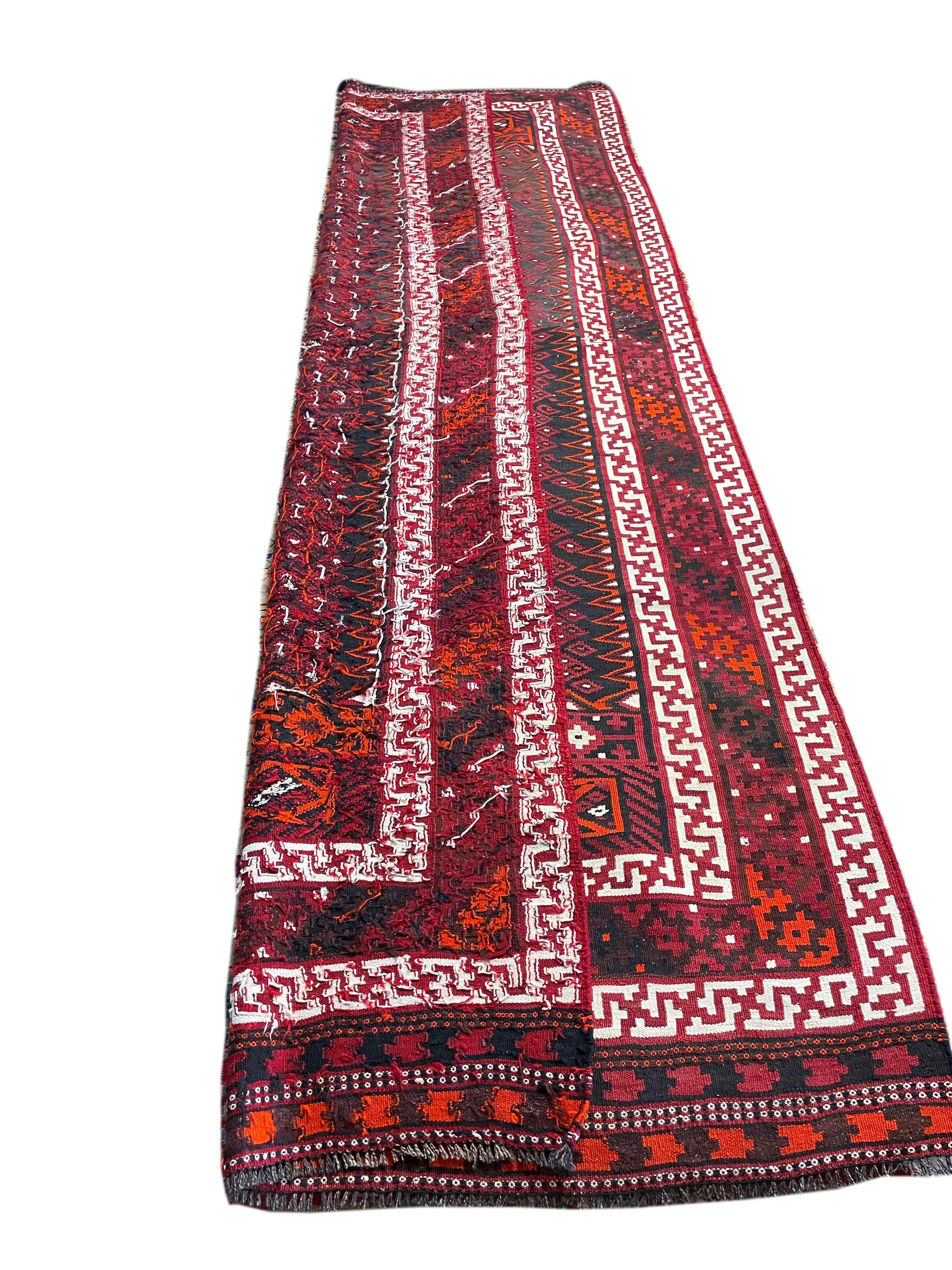 Gorgeous 60's Persian Bolouchi Kilim. This piece's tight weave and intricate needle work not only make this rug attractive, but also incredibly durable. The signature wine color of the Balouchi people makes for a pleasant color scheme that looks