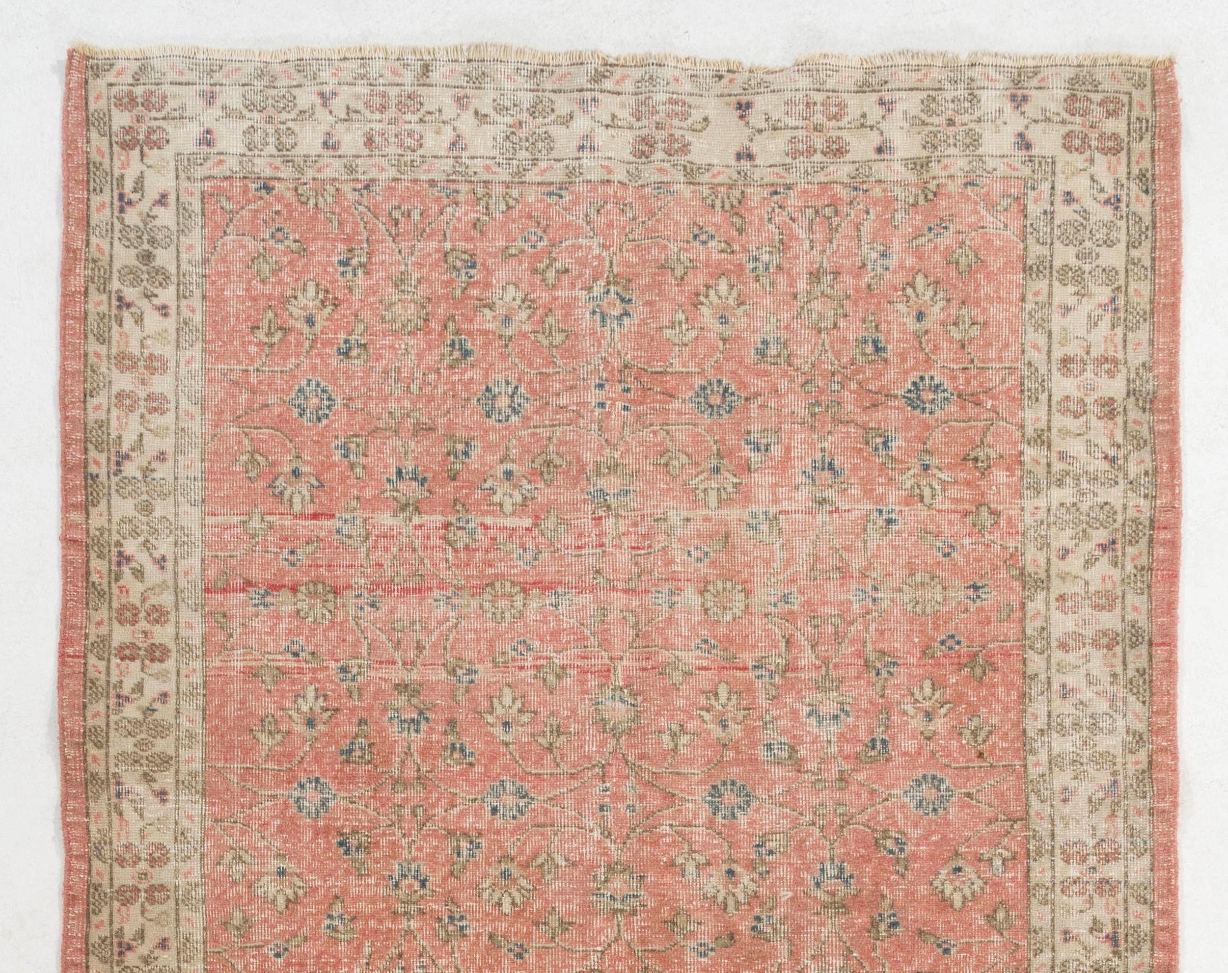 A vintage Turkish runner rug for hallway decor. It was hand-knotted in the 1960s and over-all floral design design. Sturdy and can be used on a high traffic area, suitable for both residential and commercial interiors. Measures: 5 x 12.7 ft.