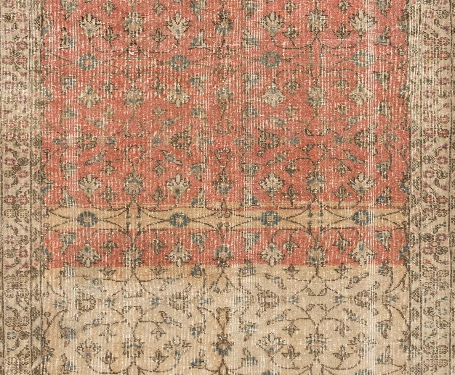 A mid-20th century hand-knotted runner from Turkey with an all-over delicate floral design in beige and dark coral pink and with wool pile on cotton foundation. In good condition, sturdy and as clean as a brand new rug. Measures: 4.8 x 12.8 ft.