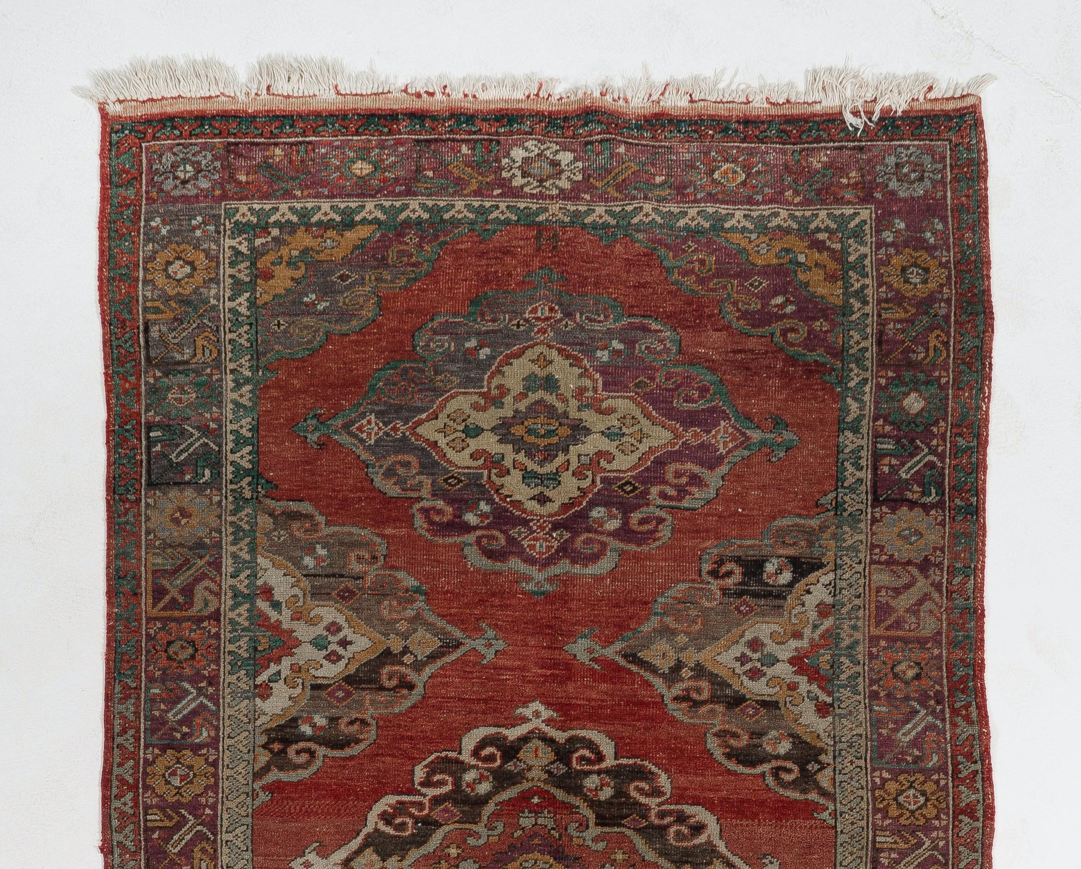 A finely hand-knotted vintage Turkish runner rug from 1940s featuring a multiple medallion design. The rug is made of medium wool pile on wool foundation. It is heavy and lays flat on the floor, in very good condition with no issues. It has been