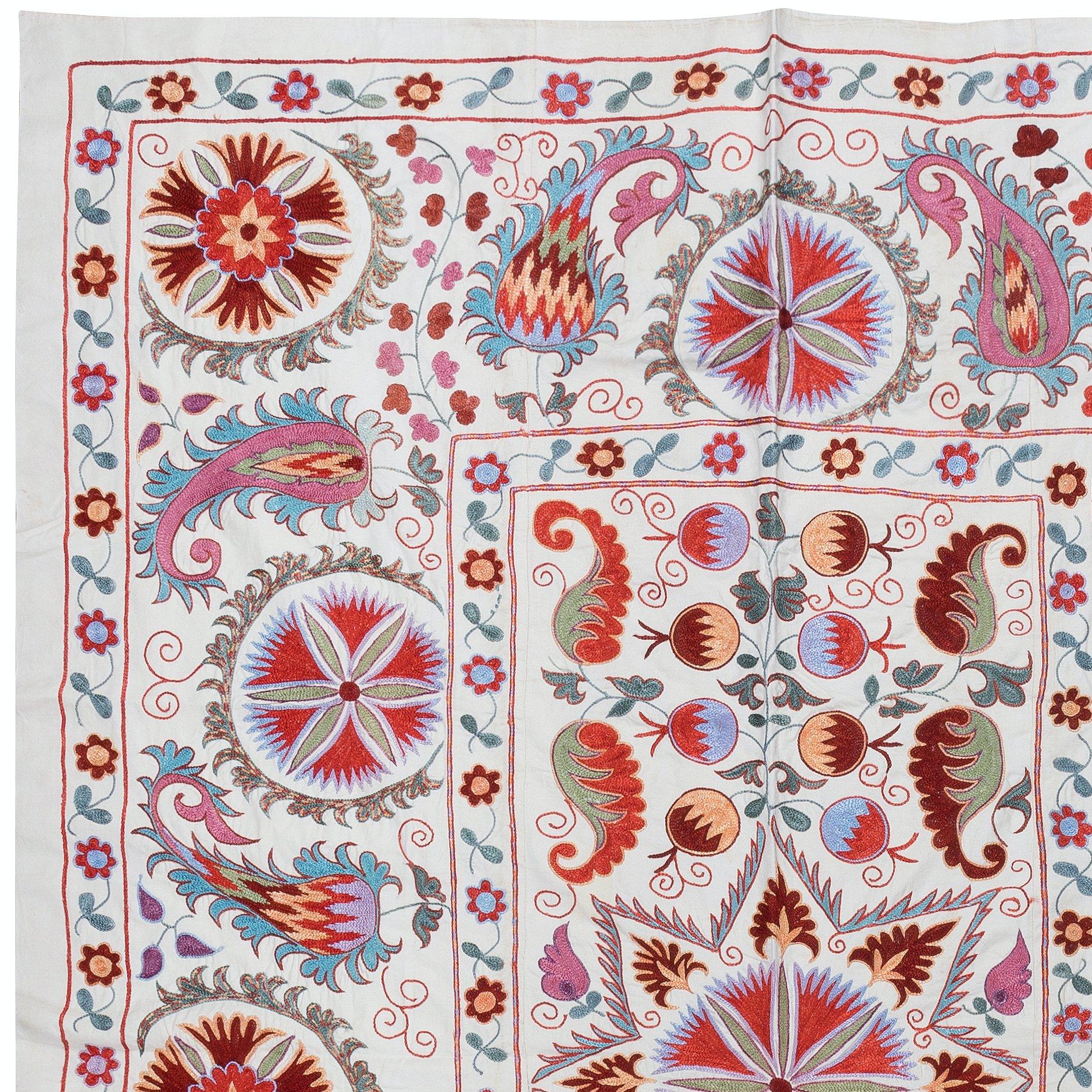 Introducing our exquisite new suzani hand embroidered wall hanging, a captivating piece that combines ancient craftsmanship with modern artistry. This embroidered cloth is not just a suzani throw, but a remarkable suzani wall hanging that will