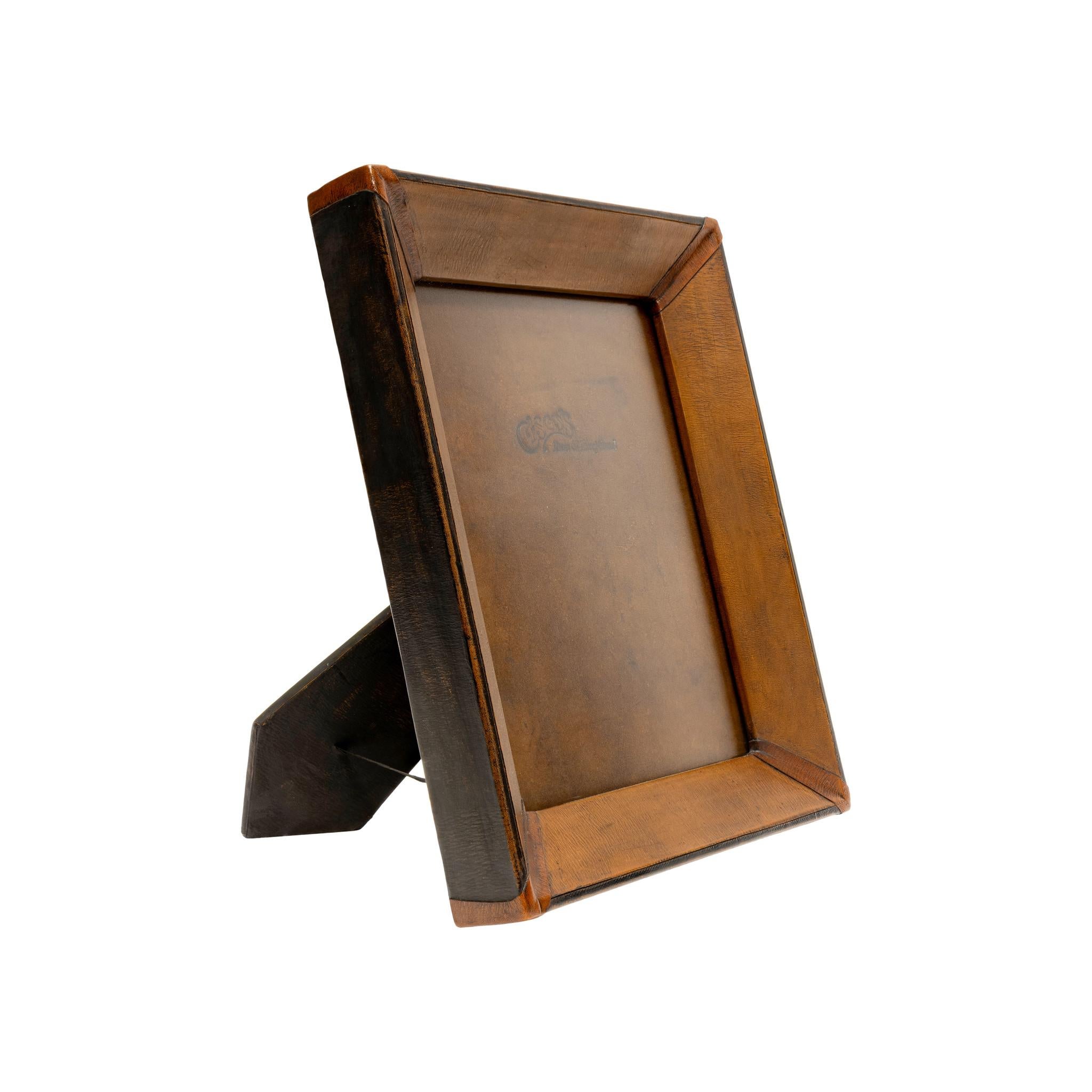 5x7 medium brown & black leather tabletop picture frame. Premium leather picture frames add the perfect accent to any home or office. Each frame is skillfully crafted by artisan saddle makers using genuine cowhide. Color: Medium brown with