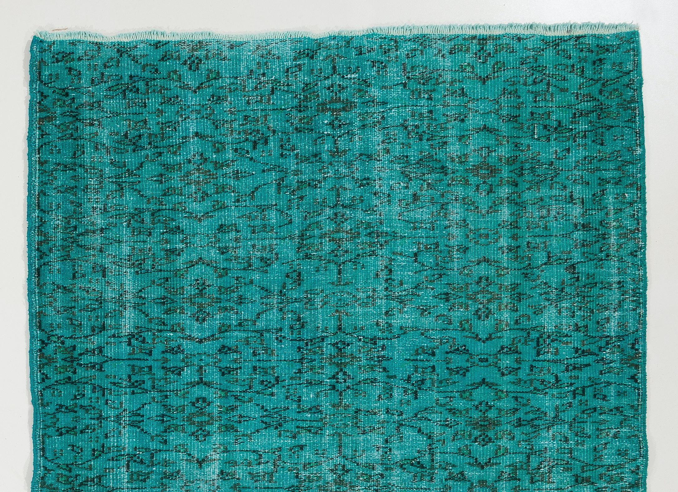 A vintage Turkish area rug over-dyed in teal color. The rug is finely hand-knotted, has low wool pile on cotton foundation. It is in very good condition, professionally washed, sturdy and suitable for areas with high foot traffic. Measures: 5 x 7.4