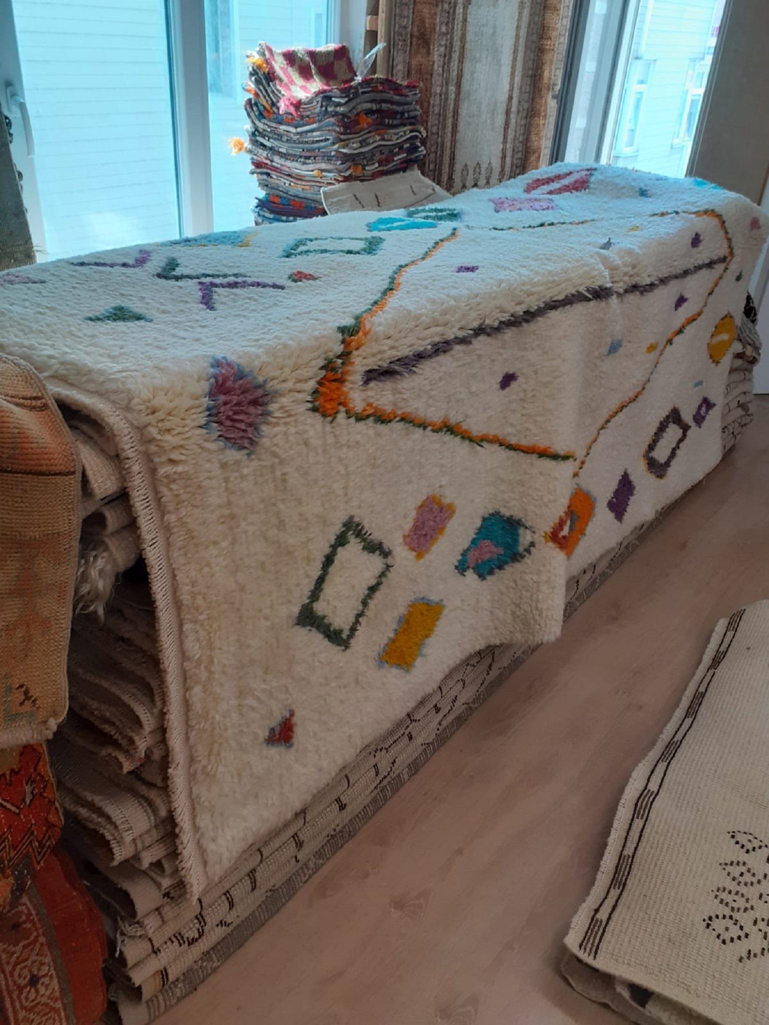 An exquisite brand-new Moroccan rug hand knotted from fine hand-spun sheep's wool with a bold, pattern in a beautiful palette of eye-catching, bright colors including bright turquoise, candy pink, burnt orange, bright orange, dark rich goldenrod,