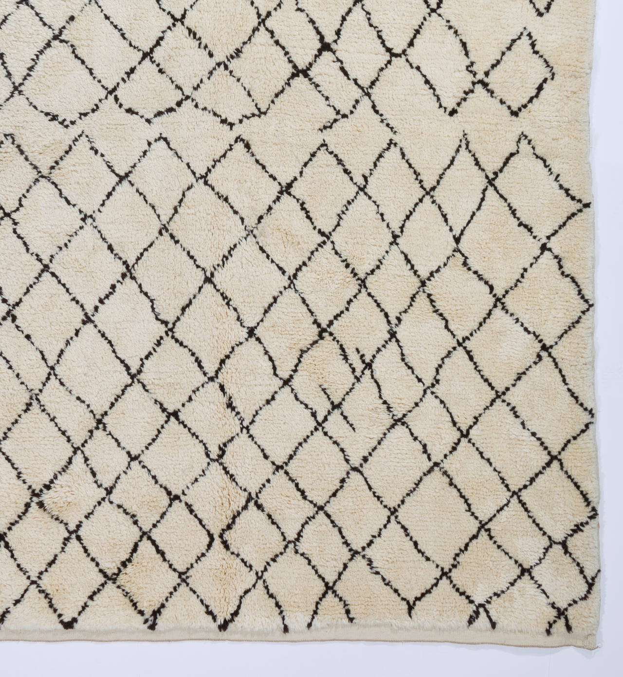 A contemporary hand-knotted Moroccan rug made of natural un-dyed wool. 
Very Soft and comfy, pleasure to walk or lay on. Available as it is, in various other sizes or made to measure in any size and color combination requested. 
Size: 5 x 8 ft.