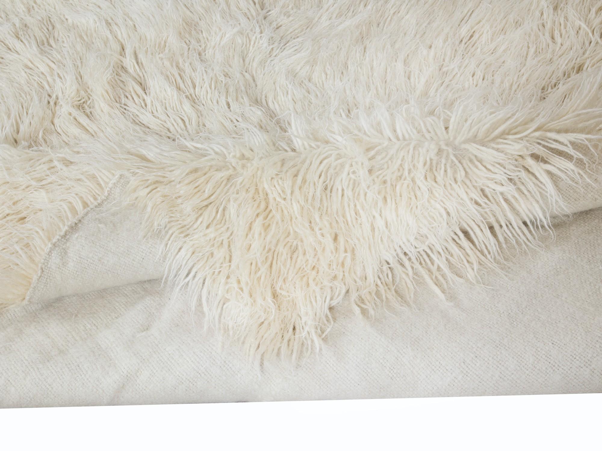 A vintage hand-knotted shag pile rug made of natural undyed mohair derived from local “Angora Goats” that are famous for their soft, lustrous long fleece. A true testament to Anatolian craftsmanship, this rug brings together the softness of mohair