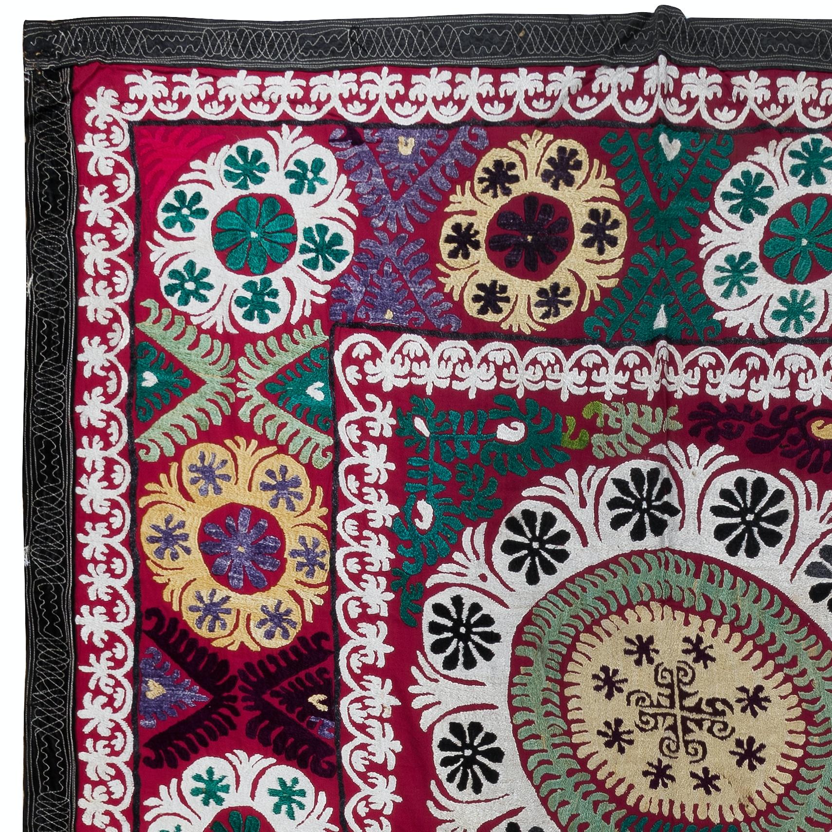 Step into a world of vibrant colors and intricate craftsmanship with our Uzbek Suzani Hand Embroidered Silk Wall Hanging or Bed Cover. This stunning piece is perfect for adding a touch of elegance to your home decor.

Made from a blend of silk and