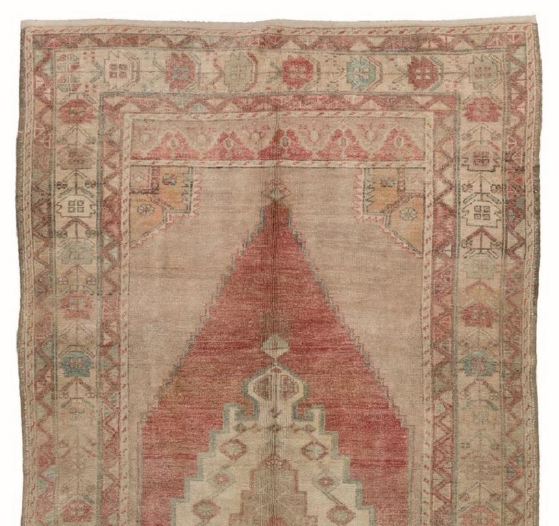 A finely hand-knotted vintage Turkish carpet from 1960s featuring a geometric medallion design. The rug is made of medium wool pile on wool foundation. It is heavy and lays flat on the floor, in very good condition with no issues. It has been washed