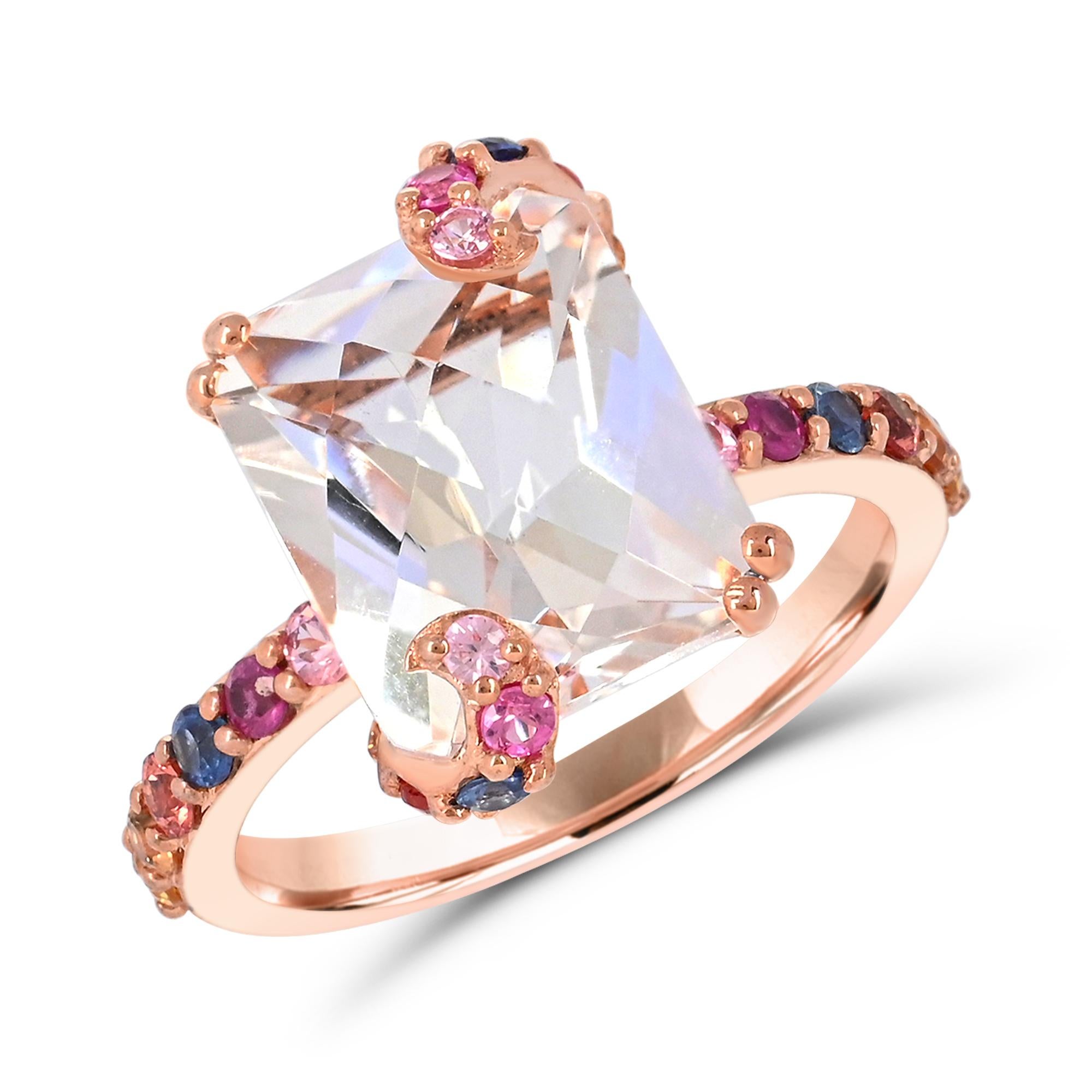 Indulge in the uniqueness of our Emerald-Cut Rock Crystal & Multicolor Sapphire Accented 14K Rose Gold Cocktail Ring. Crafted with meticulous attention to detail, this ring boasts a spectacular combination of one 5-7/8 carat emerald-cut rock crystal