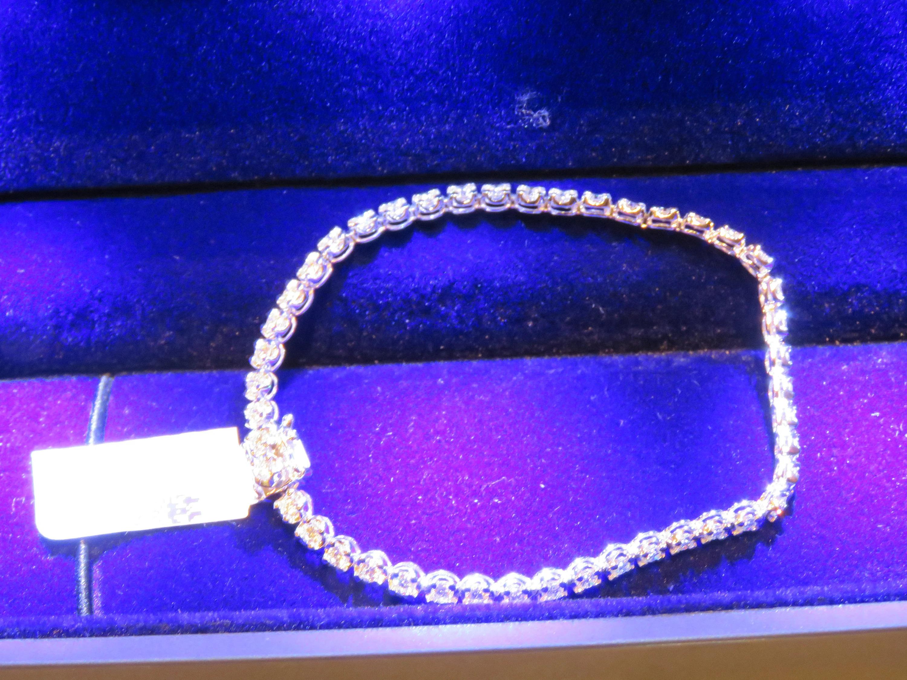 The Following Item we are offering is this Rare IMPORTANT SPECTACULAR 18KT WHITE GOLD LADY'S FULL ROUND CUT BRILLIANT WHITE DIAMOND TENNIS BRACELET. BRACELET IS MAGNIFICENTLY ADORNED WITH GORGEOUS GLITTERING WHITE DIAMONDS TOTALING APPROX 2