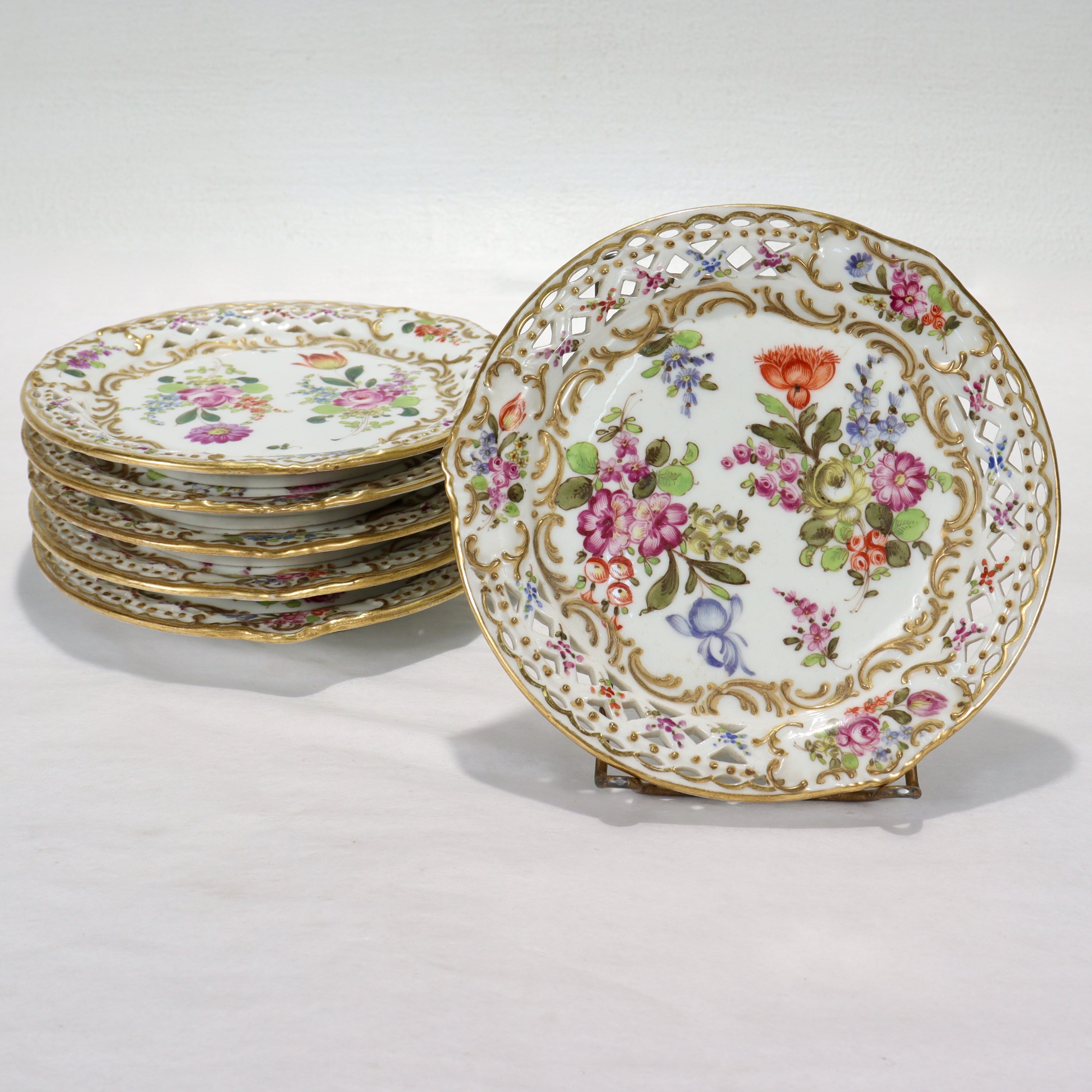 A set of 6 fine French reticulated porcelain plates.

By Bloch & Bourdois.

Decorated throughout with floral sprays, raised gold, gilt highlights, and a reticulated rim.

Simply a great set of French porcelain Dresden style