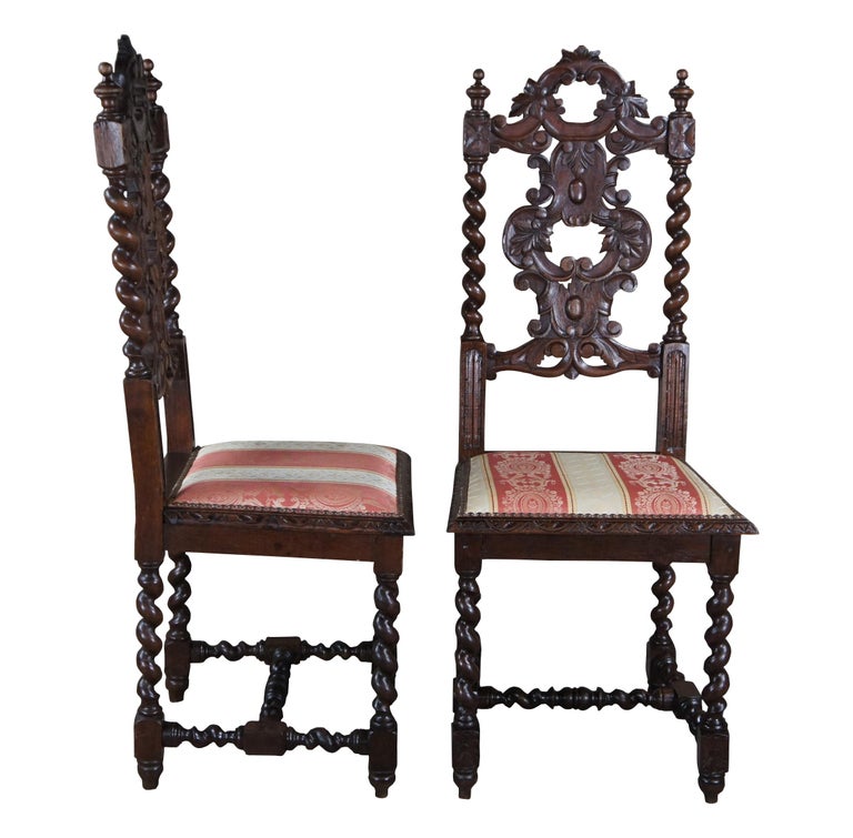 Six antique French Renaissance Revival dining chairs, circa 1920s. Made of oak featuring ornate gothic styling with a pierced / reticulated back, carved leaves over scrolled accents and barley twisted fluted stiles. Upholstered silk seats feature