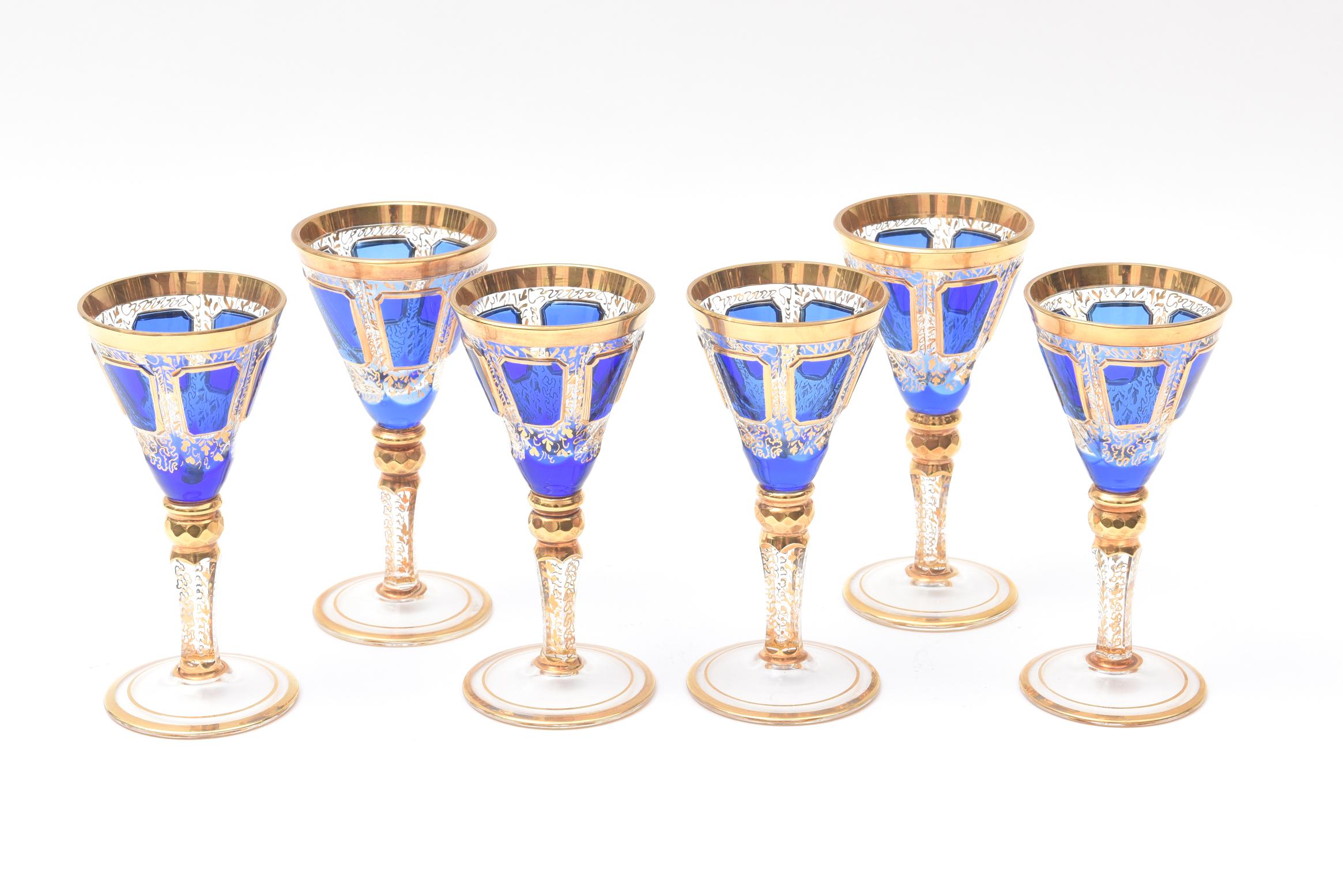 A handsome and Classic set of last quarter 19th century pieces from Moser, The Glass of Kings. These delightful after dinner cordials feature cabochon jewel style decoration and hand painted gilt in an all-over scroll pattern. In wonderful antique