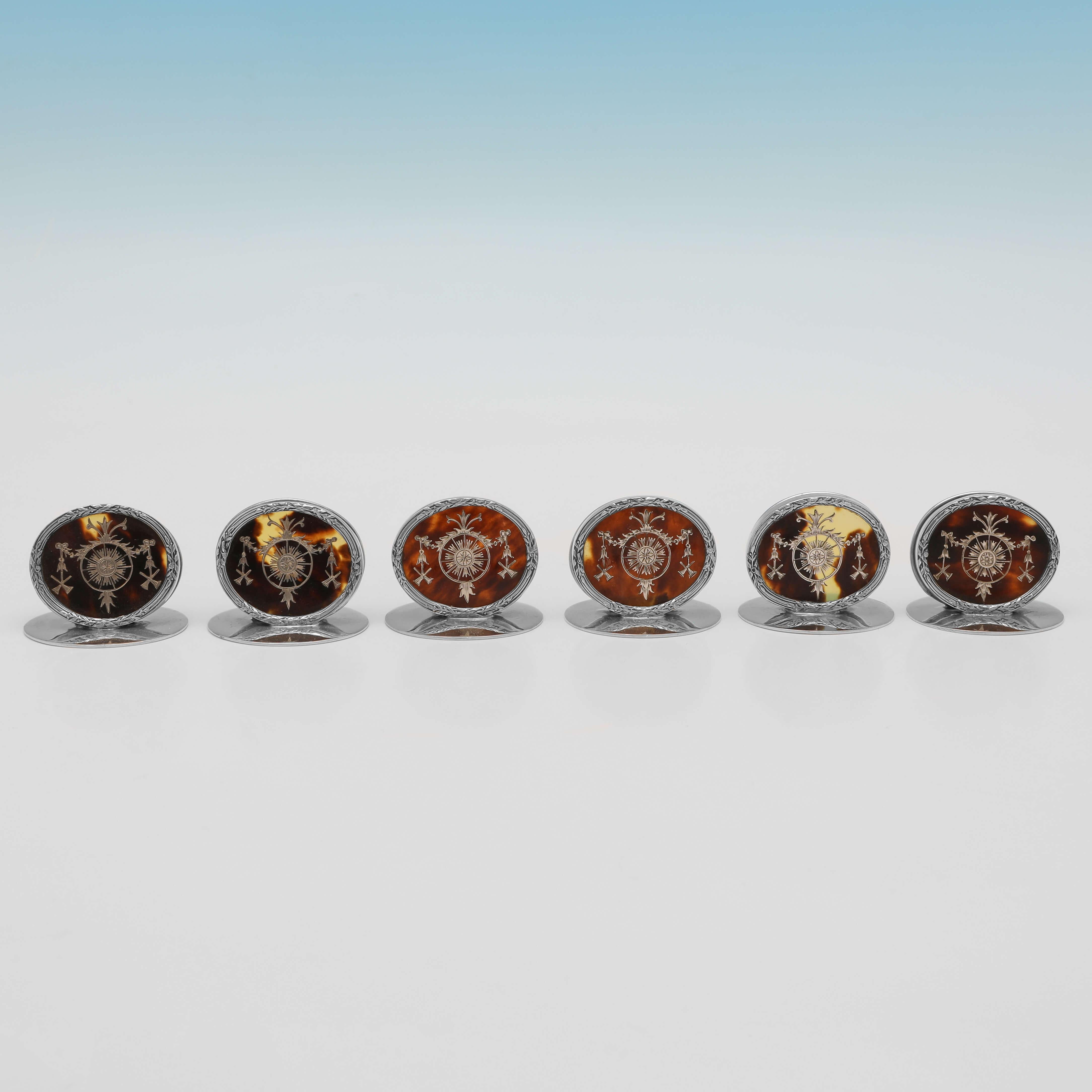 Hallmarked in London in 1914 by William Comyns, this very attractive set of 6, Antique Tortoiseshell & Sterling Silver Place Card Holders or Menu Holders, feature silver inlay to the tortoiseshell and are presented in their original box. Each place