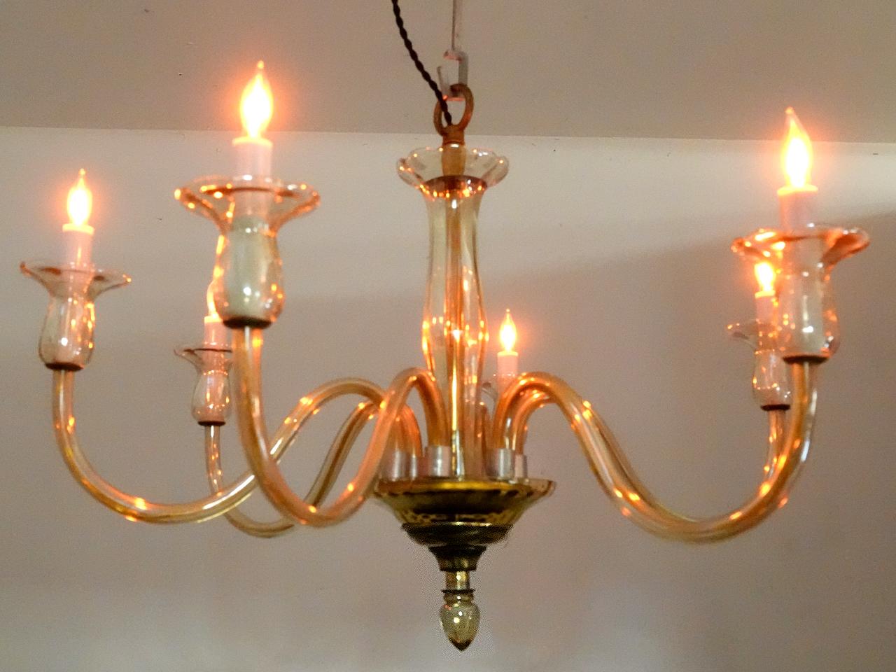 For Murano Glass this is a very simple and elegant example example. This warm color glass is referred to as Champagne. The fixture has 6 arms using Candelabra E12 bulbs. Wire and sockets are all restored and new.We will finish to your drop length.