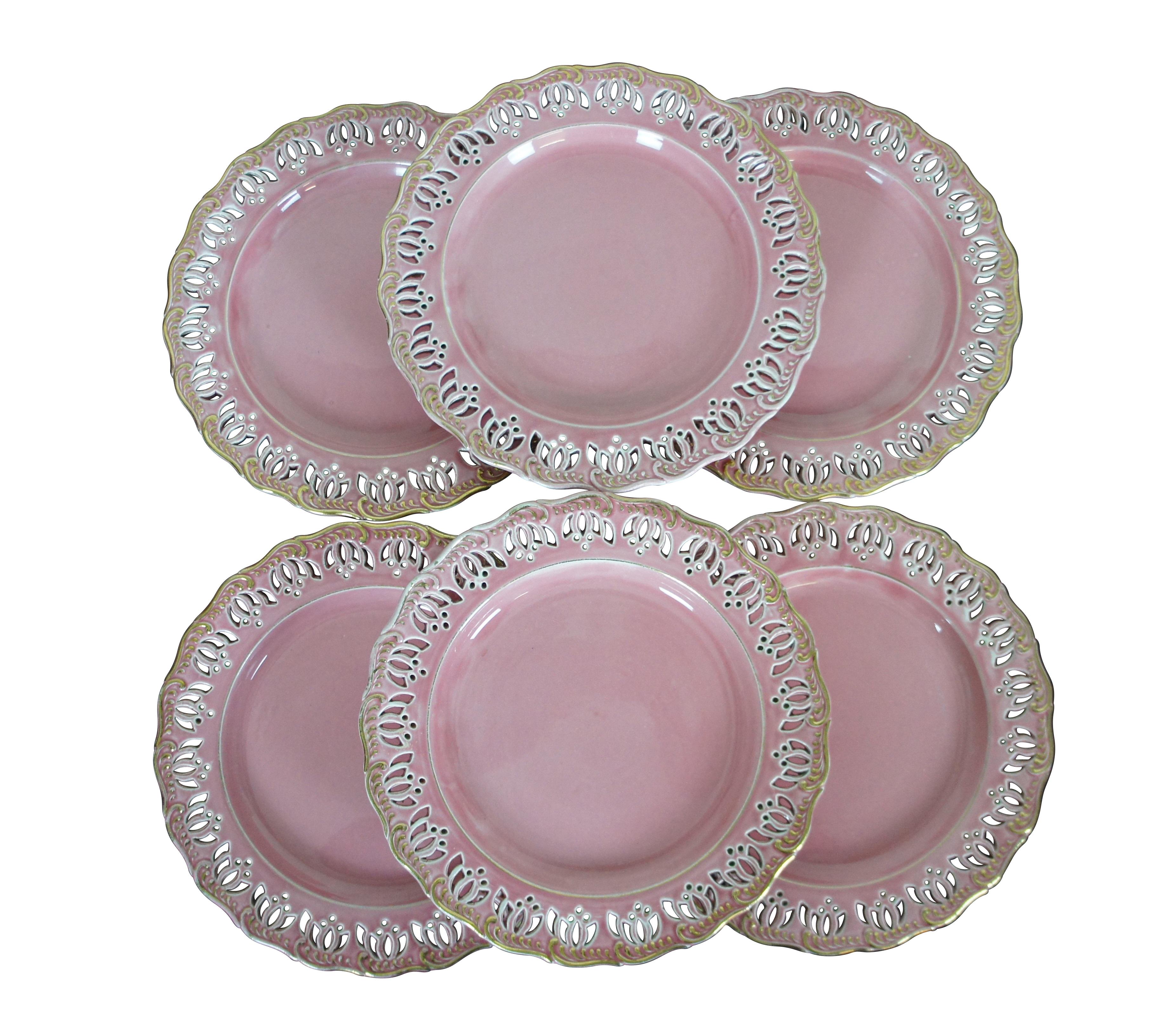 Six antique Austrian / Hungarian pink stoneware plates featuring a scalloped pierced lotus flower design.  Marked with Vienna beehive and F Y W.

Dimensions:
8.5