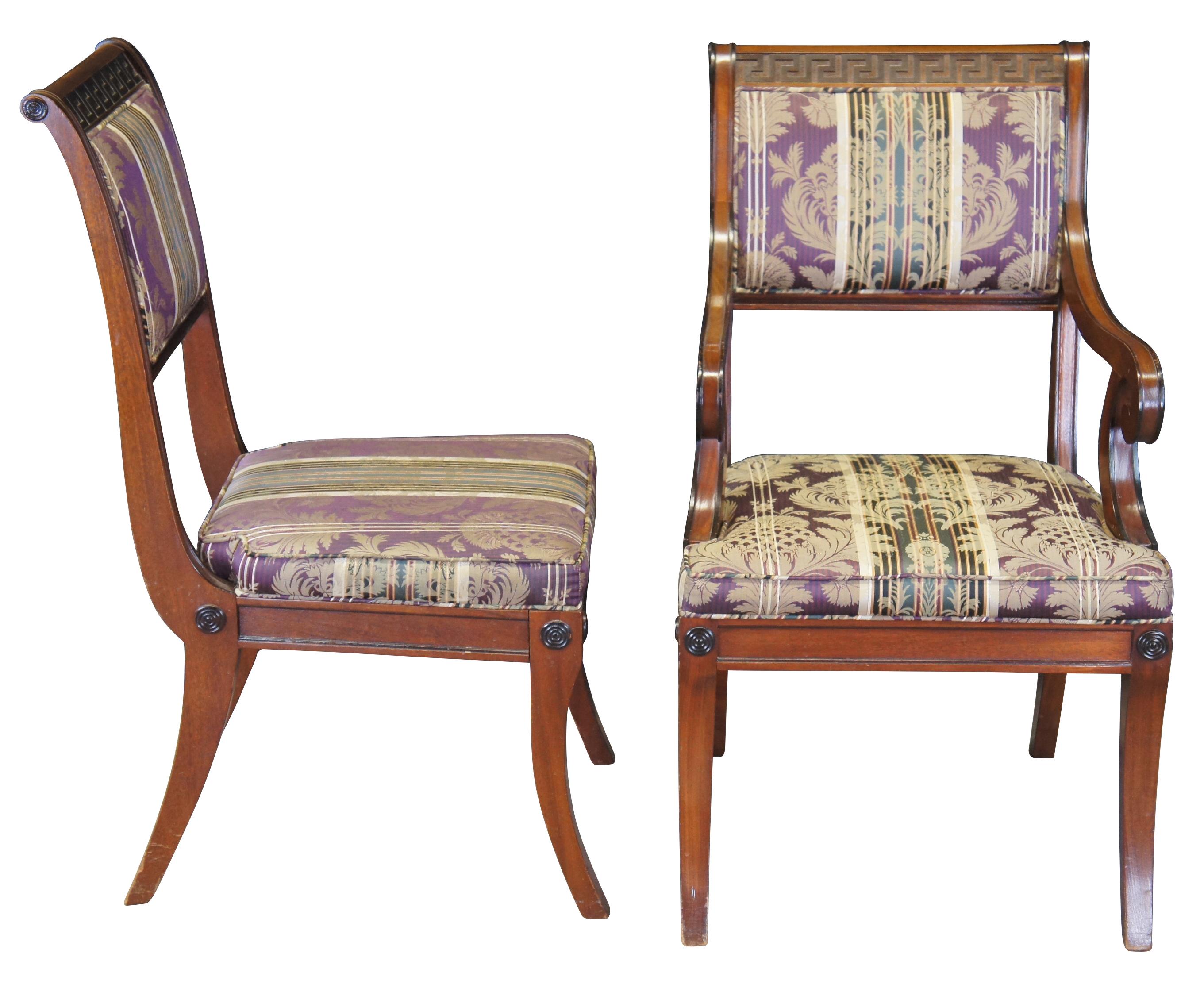 Beautiful set of 6 dining chairs by Baker Furniture, circa last quarter 20th century.  Inspired by English Regency and Klismos styling.  Features a mahogany frame with carved ebonized Greek key accents and rounded medallion embellishments.  The