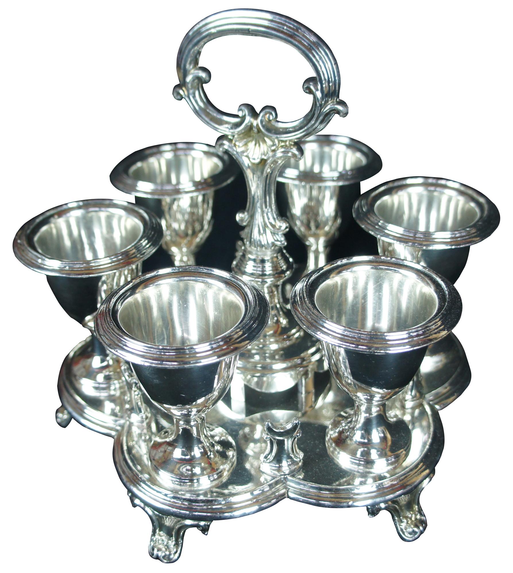 Vintage silver plated kiddish cups and caddy. Features baroque design with scalloped footed form and fitted glasses for ease of use.

Measures: 8