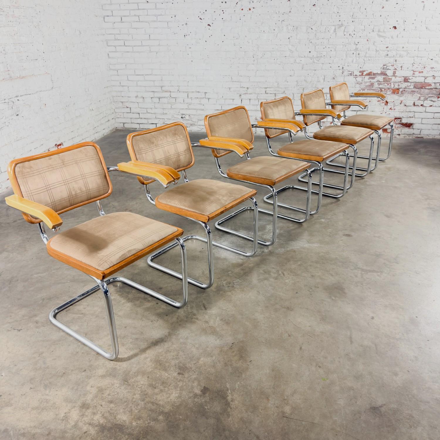 Marvelous vintage Bauhaus style armchairs in the style of Marcel Bruer Cesca Chair comprised of chrome tube cantilever bases, new beech wood arm rests, & top-stitch milk chocolate brown ultra suede upholstered seat & backs. Made in Italy and a set
