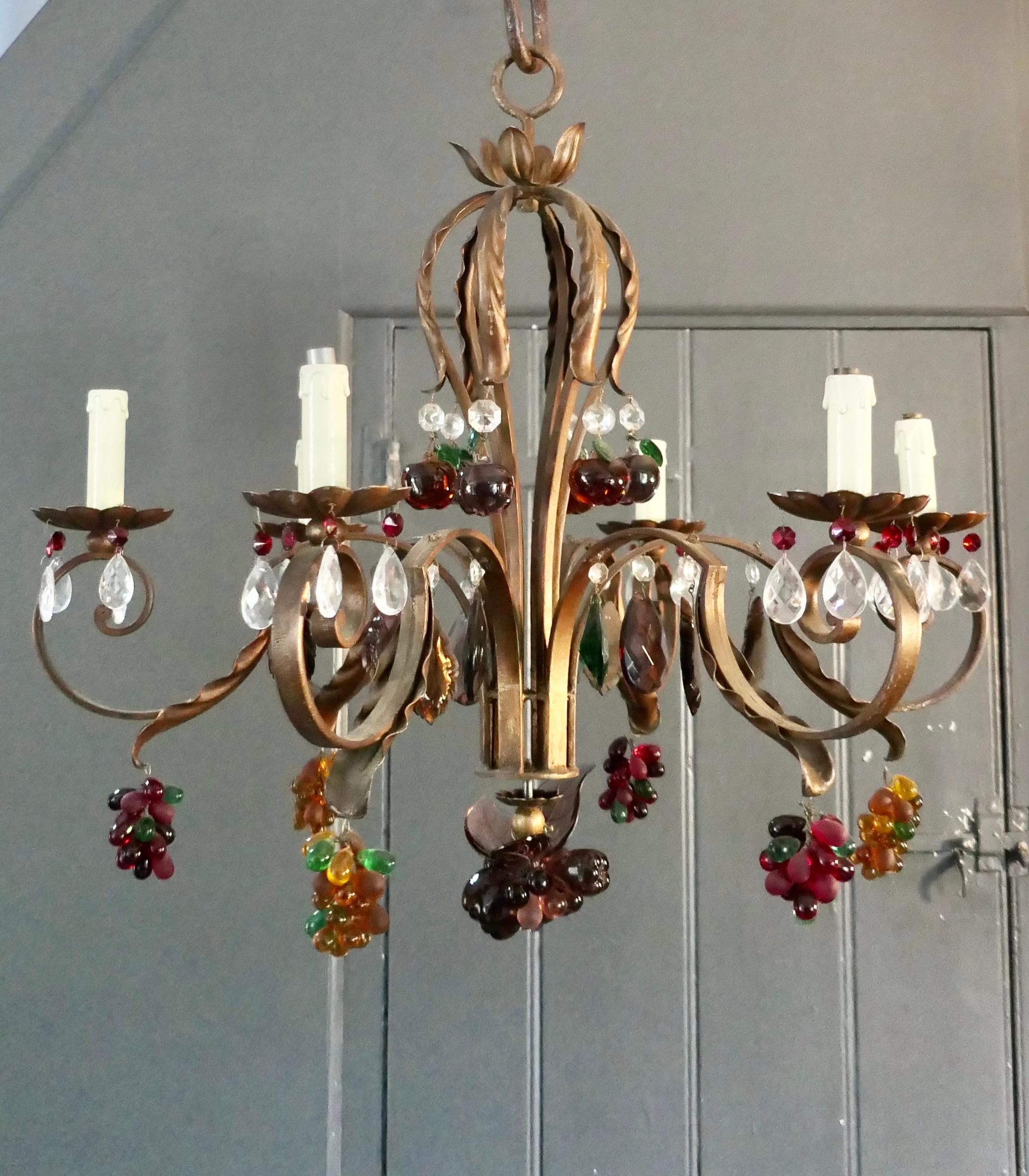 6 Branch Chandelier Hung with Coloured Crystal Fruits, Grapes, Apples and Pears

This is a stunning piece, the aged gilt iron frame is hung with bunches of Amber, Ruby and Green Grapes, Apples and Pears with occasional green and wine leaves
A truly