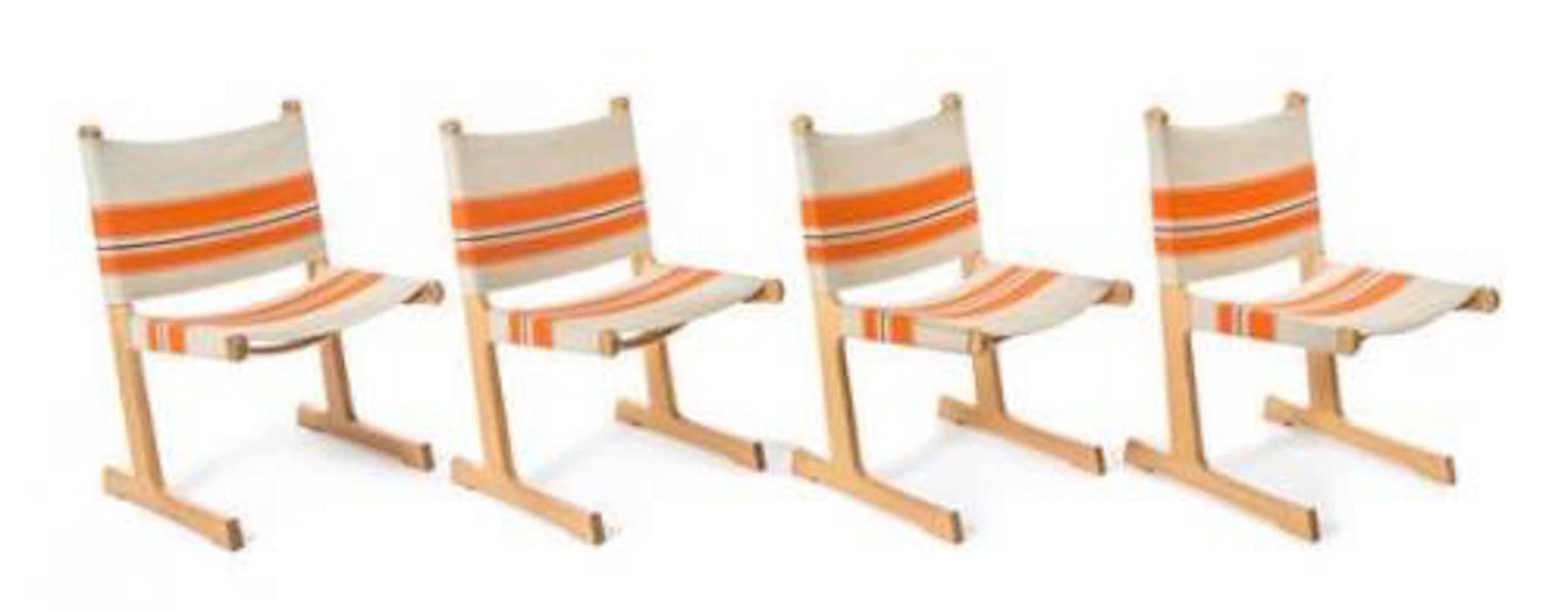 Six cantilevered Danish dining chairs by Ditte and Adrian Heath for France & Son
Constructed of oak and stripped canvas
Retailed by John Stuart.

         