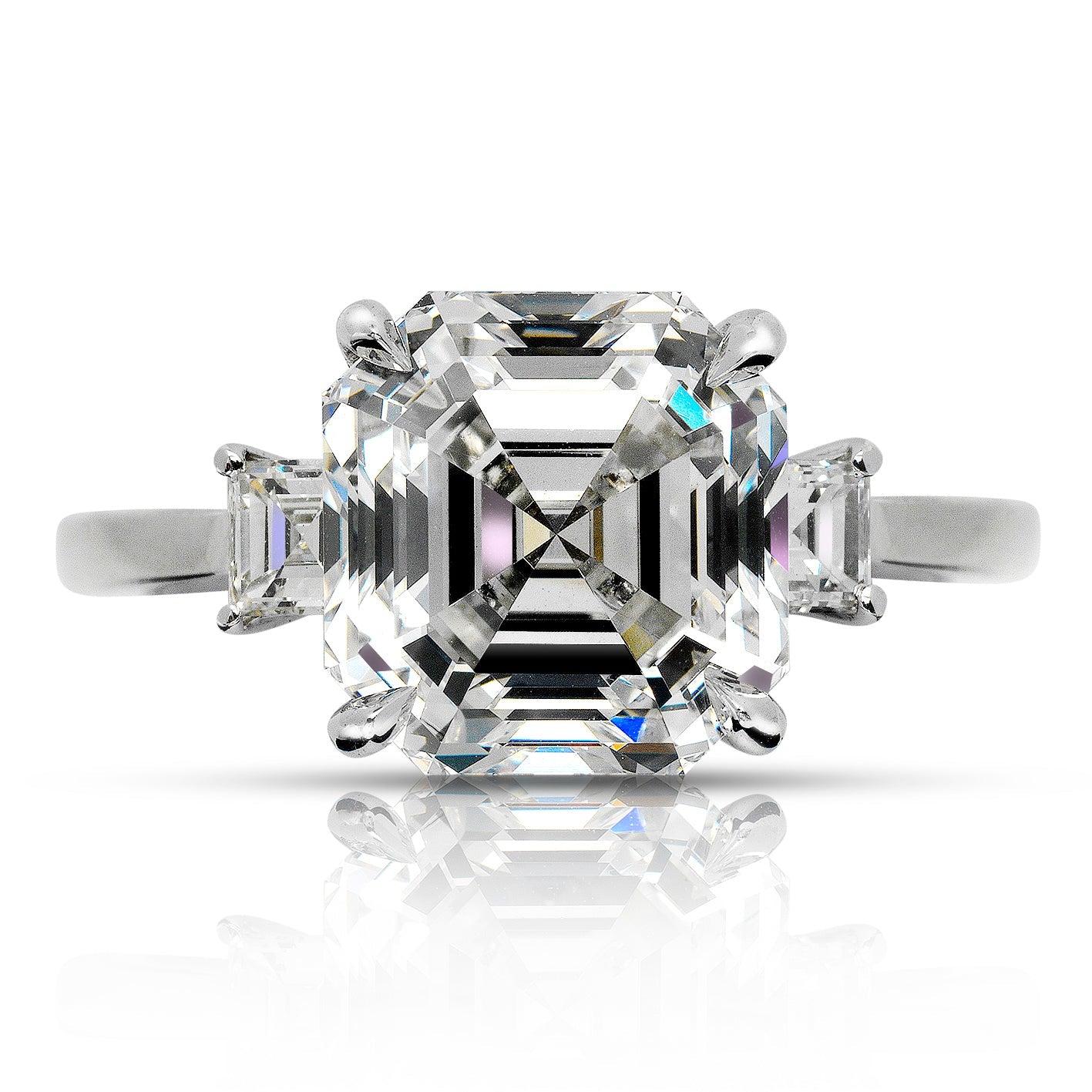 MAVIA -ASSCHER THREE  STONE DIAMOND ENGAGEMENT RING BY MIKE NEKTA
GIA CERTIFIED


Center Diamond:
Carat Weight: 5 Carats
Color : E
Clarity: VVS1
Style: ASSCHER CUT / SQUARE EMERALD CUT
Approximate Measurements: 9.6 x 9.2 x 6.5 mm
 
Ring:
Metal: 18K