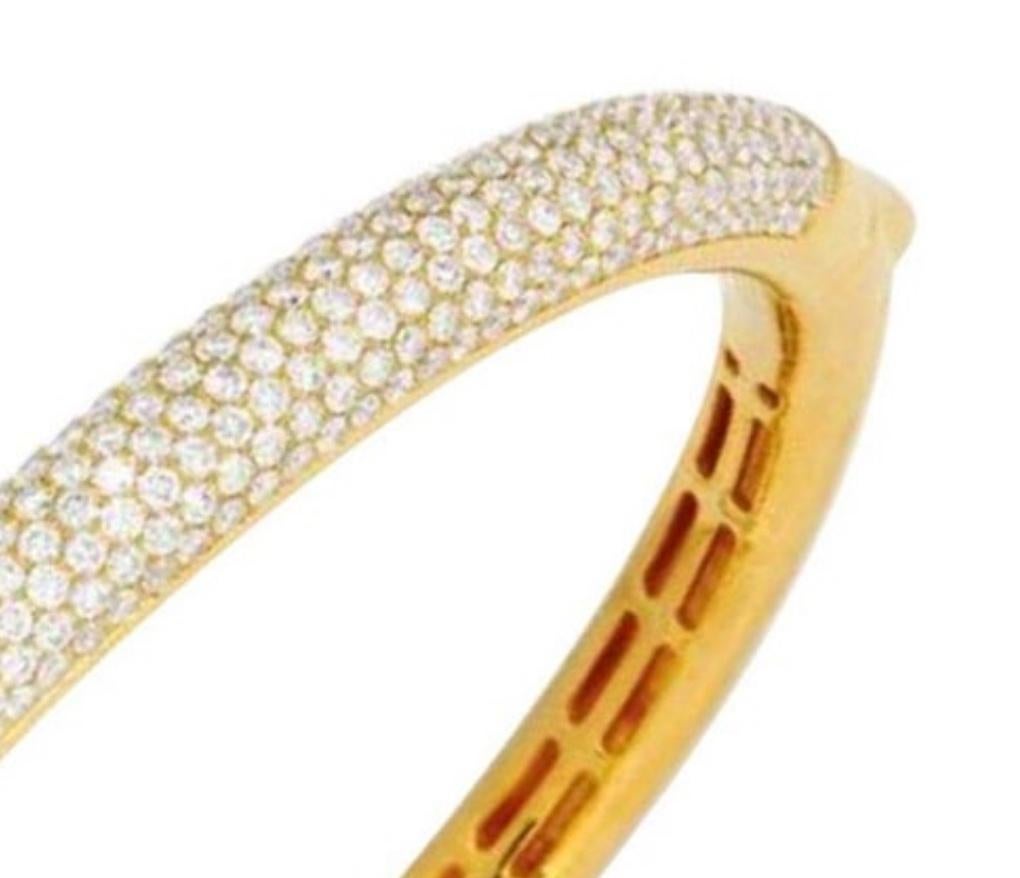 The oval hinged hoop decorated at the front with a bomb panel of pav-set round diamonds weighing approximately 6.00 carats , mounted in highly polished 14k gold, inner circumference 6 1/2 inches

Condition Report: Dimensions: 7 mm wide 

Color: H-I