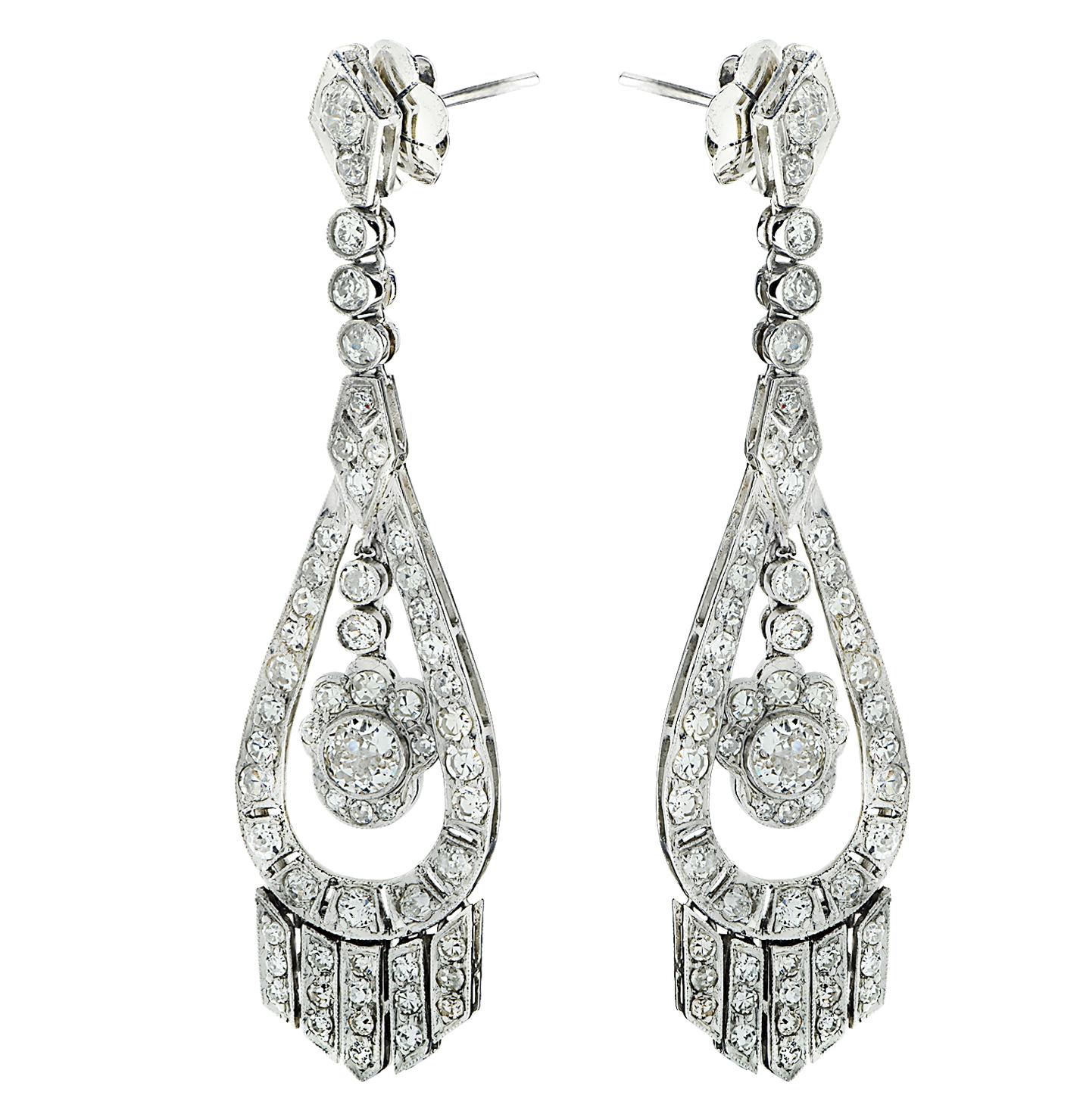 Beautiful diamond dangle earrings crafted in platinum, featuring Single cut and Old European Cut diamonds weighing approximately 6 carats total, H-I color, VS-SI clarity. The diamonds are arranged in an ornate design showcasing two Old European Cut