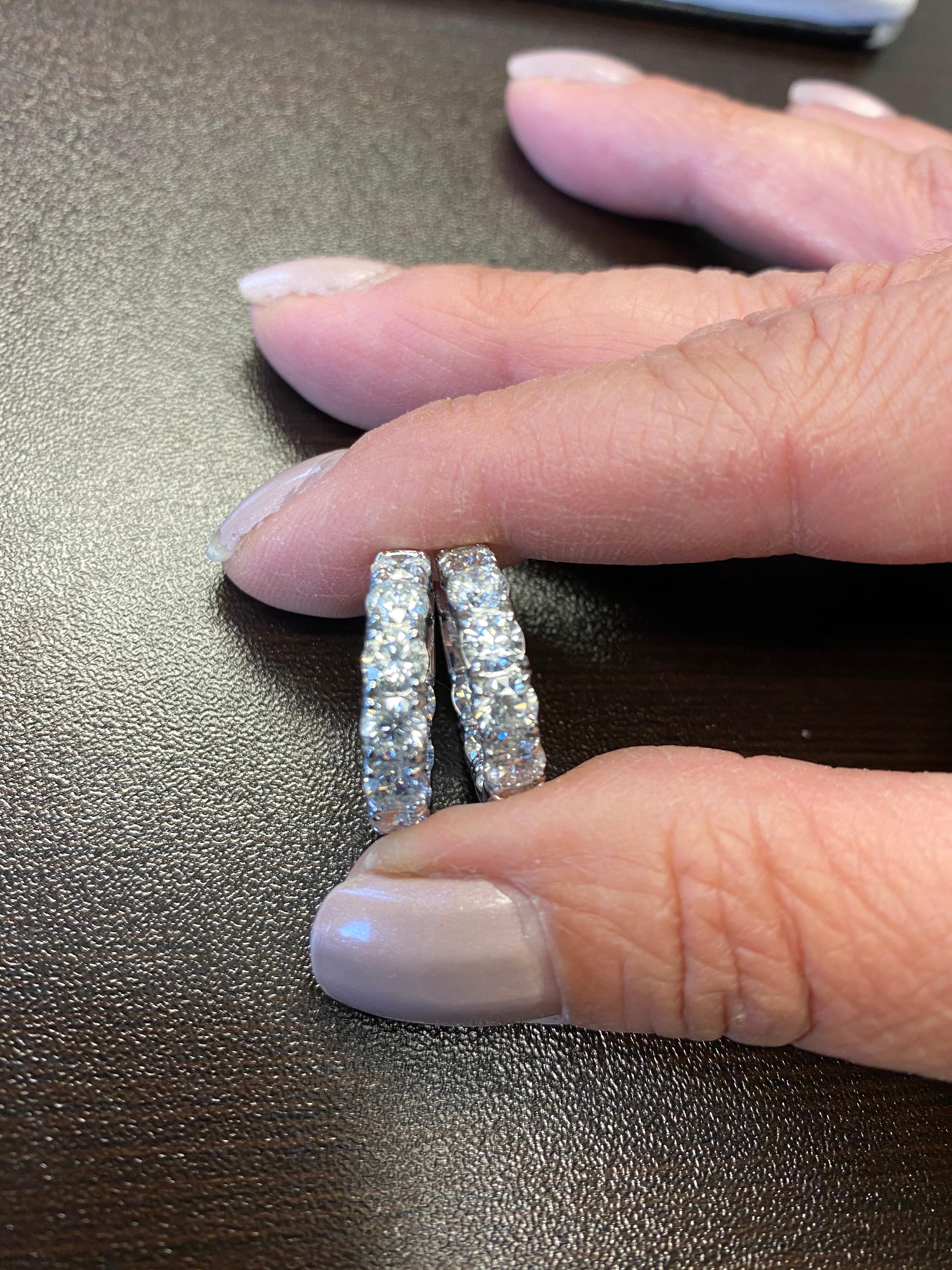 Diamond hoop earrings set in 14K white gold. Each stone weighs 0.35 carats. The color of the stones are G, the clarity is SI1-SI2. The total diamond weight of the earrings is 6.02 carats. The diameter of the hoops is 3/4 of an inch. 
