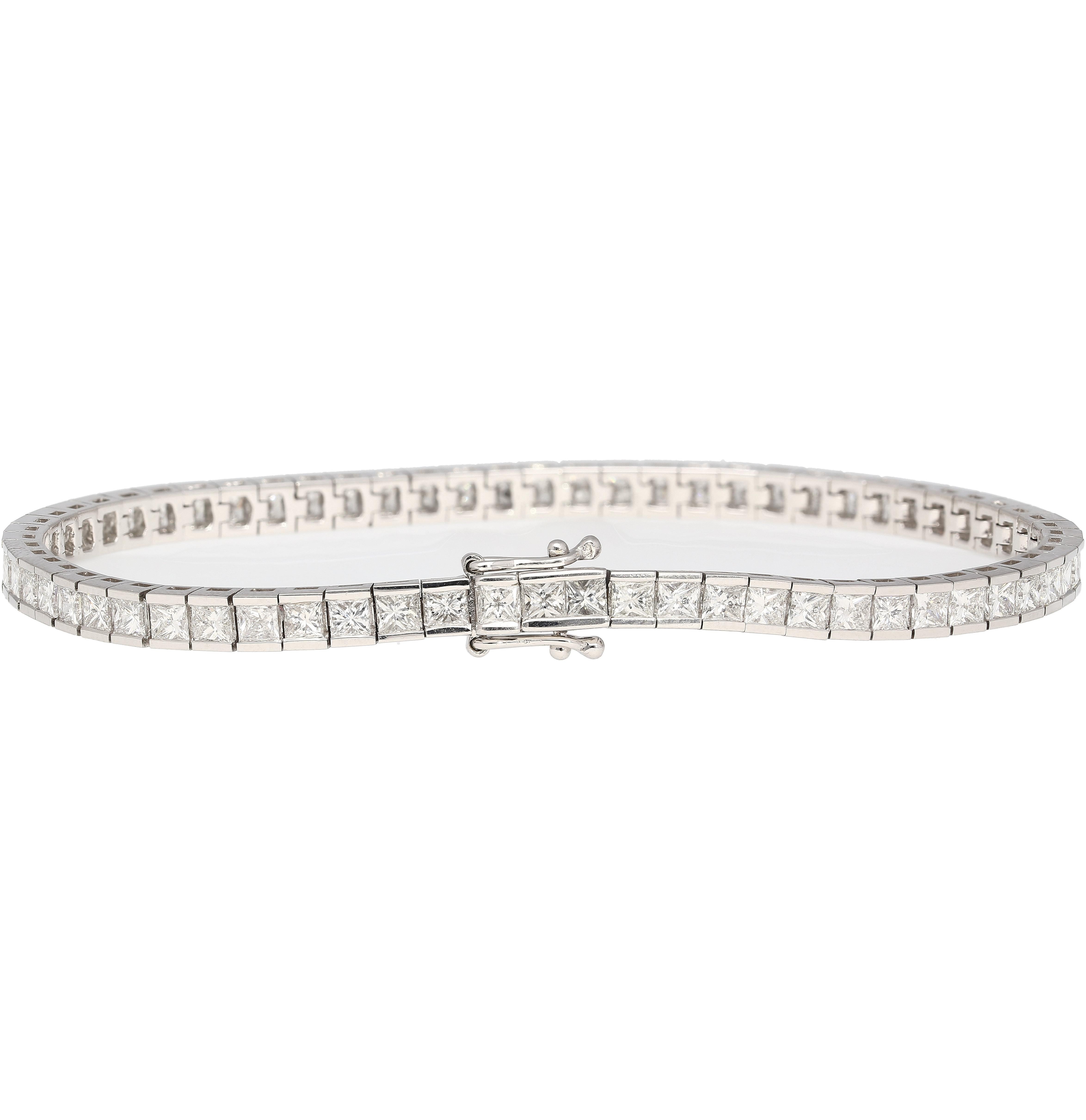 6-carat total princess cut natural diamond tennis bracelet in 18k white gold. Fitted with a secure box and safety closure. The stones are all eye clean, superbly white, and full of life. Set in a half-bezel channel setting that perfectly integrates