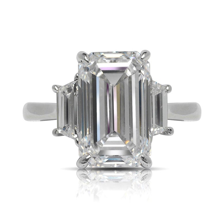 SEDA EMERALD CUT  THREE STONE DIAMOND ENGAGEMENT RING IN PLATINUM 
GIA CERTIFIED


Center Diamond
Carat Weight: 5 Carats
Color :  E*
Clarity:  VS1
Cut: EMERALD CUT
Measurements: 12.1 x 7.5 x 5.1  mm
*Color Treated
 
Ring:
Metal: PLATINUM
Style: