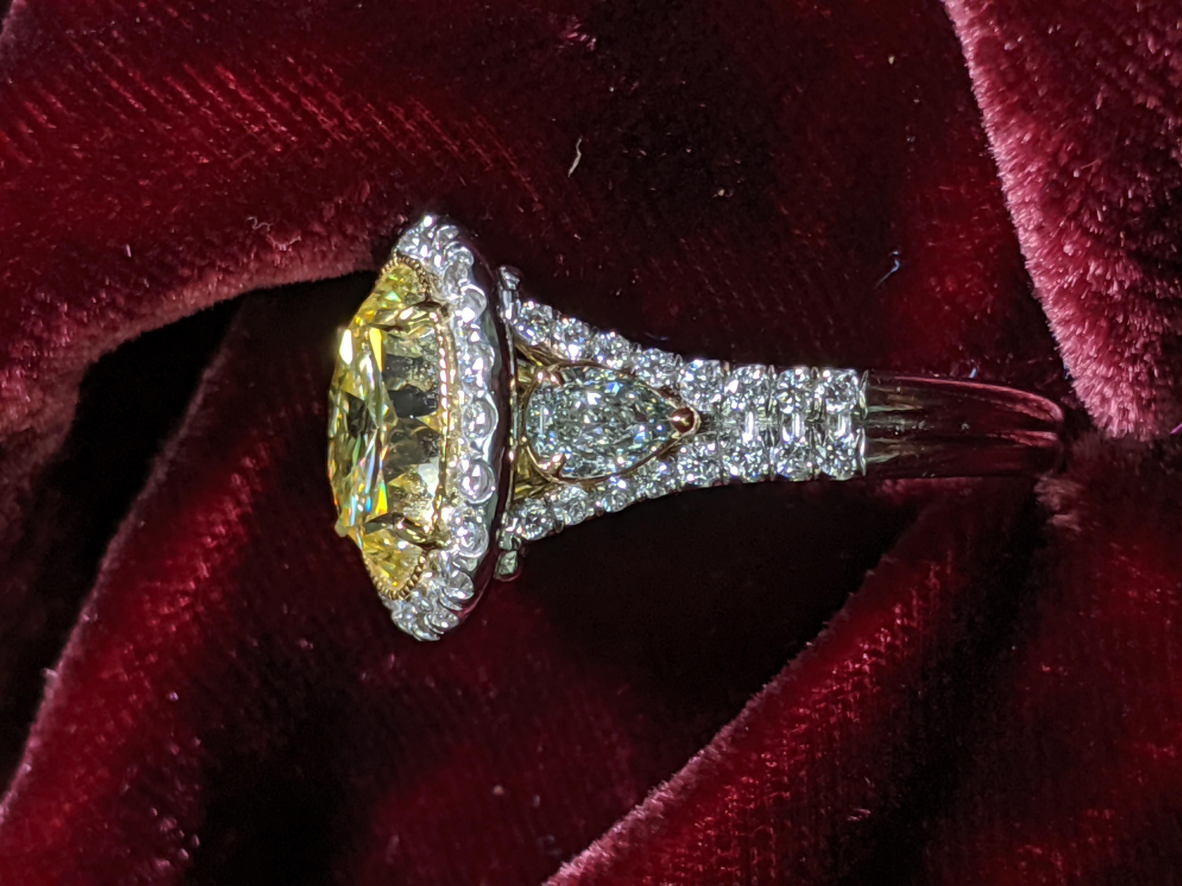 Rare SIX carat Fancy Intense Yellow Round Diamond mounted in a handmade Platinum mounting with side pear shape diamonds and smaller white diamond outline.  The ROUND shape is extremely rare in natural fancy color diamonds and definitely make a