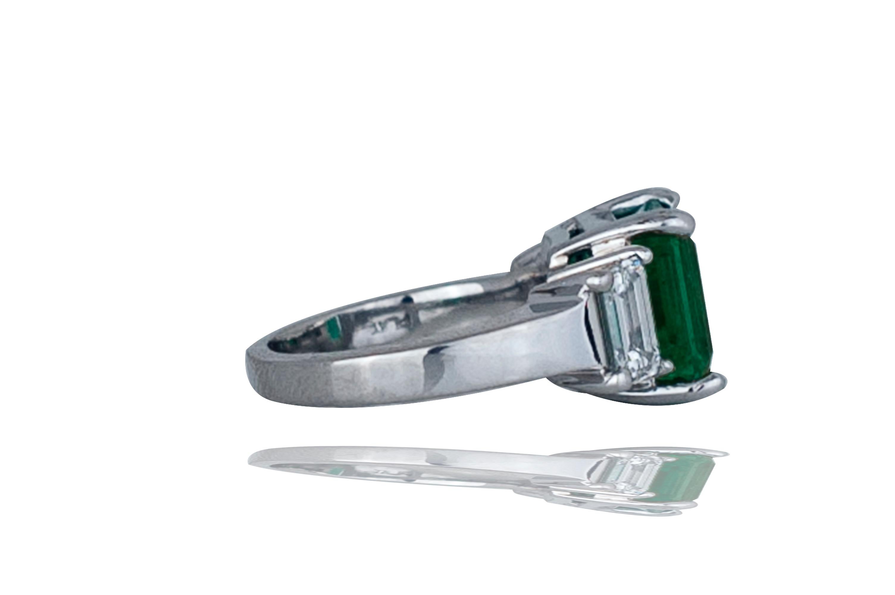 This gorgeous green Colombian emerald is to die for.  The center stone is a emerald cut Colombian emerald which is GIA certified.  Coming from arguably the best location in the world, this emerald shows the color of what a true emerald should be. 