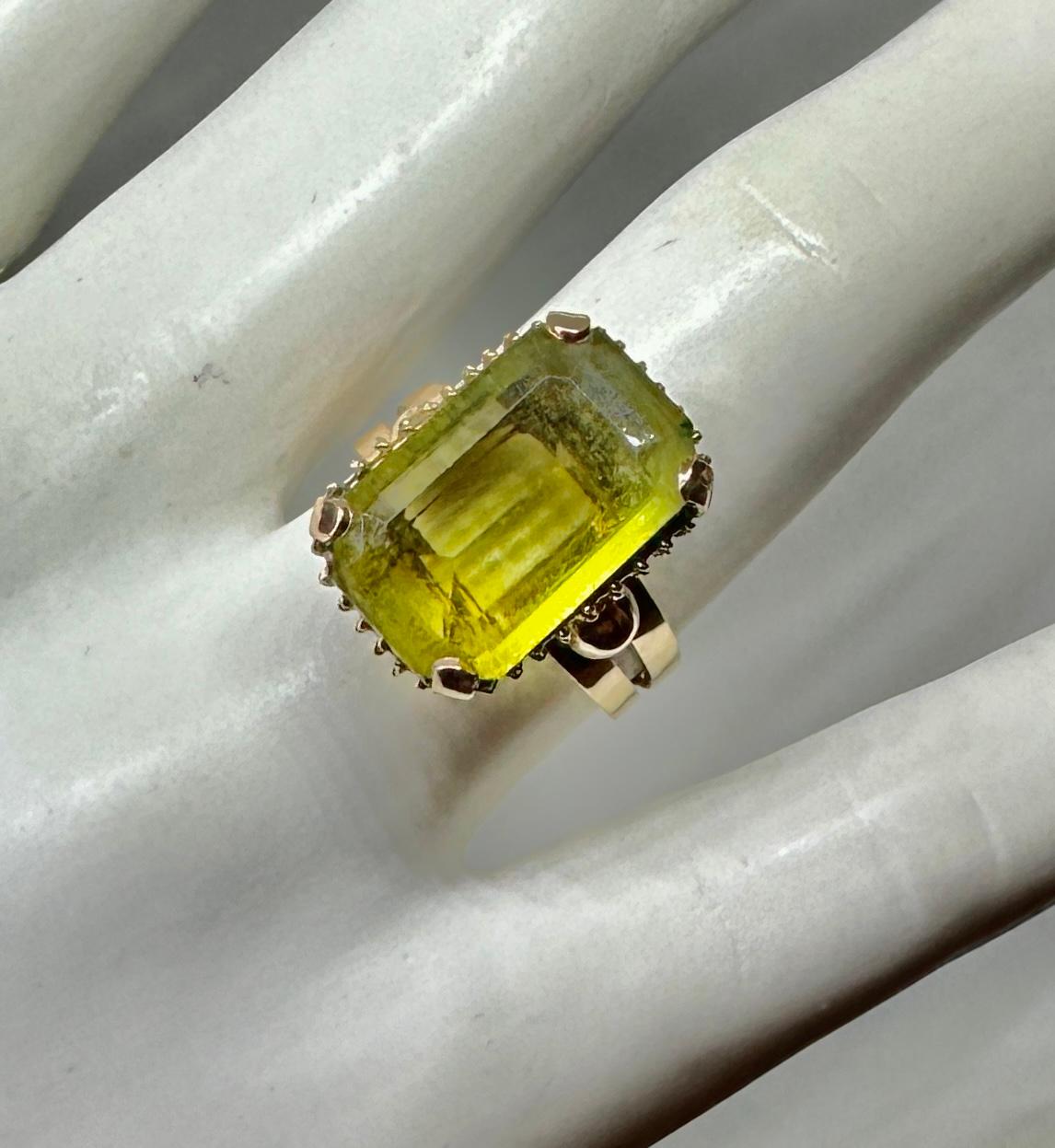 This is a stunning Art Deco - Retro 6 Carat Emerald Cut Green Quartz Ring in a 14 Karat Rose Gold raised setting of great beauty.  The ring has a gorgeous 6 Carat Emerald Cut Green Quartz gem with lovely color.  The dramatic long emerald cut of the