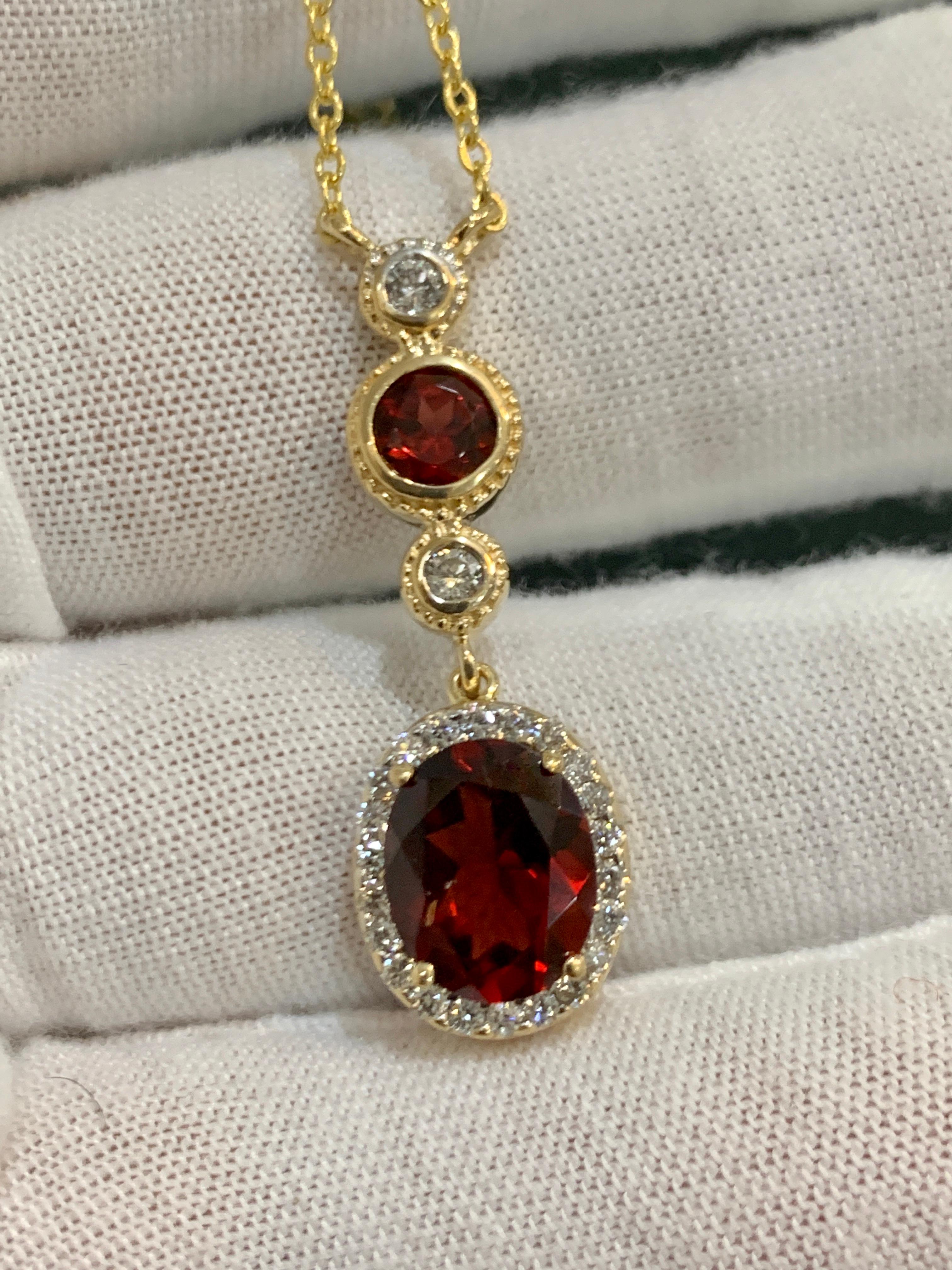 Women's 6 Carat Oval Shape Garnet and 0.6 Carat Diamond Necklace in 14 Karat Yellow Gold For Sale