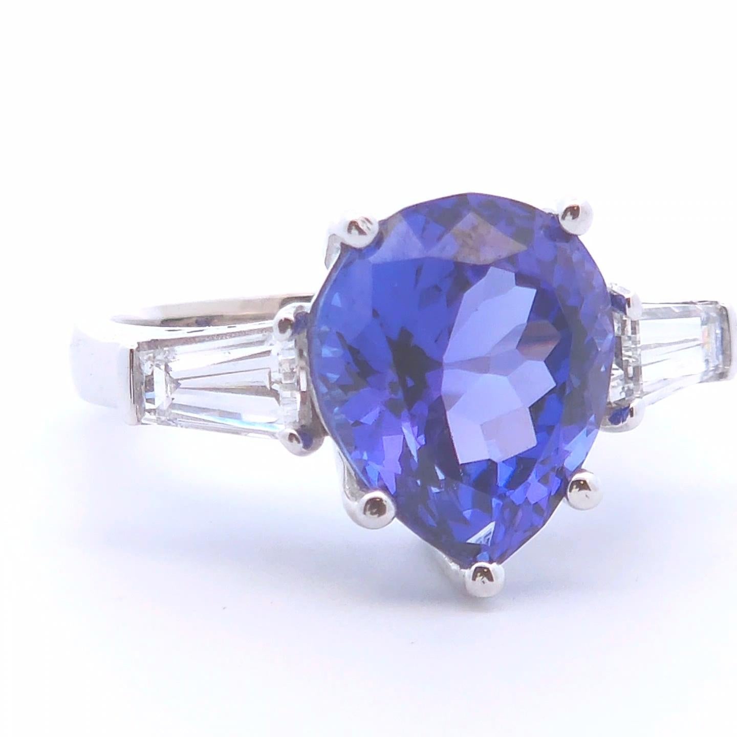 This stunning 6-carat pear-shaped tanzanite ring is a true statement piece, set in luxurious 14k gold. The mesmerizing tanzanite gemstone displays rich blue-violet hues, enhanced by expert faceting that maximizes its brilliance. Designed for