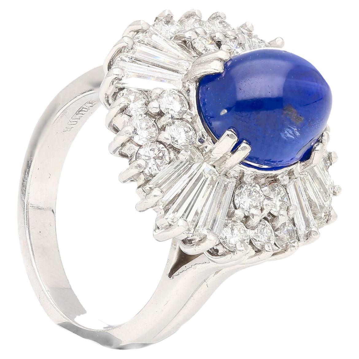 GRS Certified No Heat Burma 6.03 Carat Cabochon Cut Royal Blue Star Sapphire and Diamond Halo Cocktail Ring. 

Featuring 12 baguette cut and 20 round cut diamonds, set in a wide frame multi-layered halo. Set in platinum. The center stone originates
