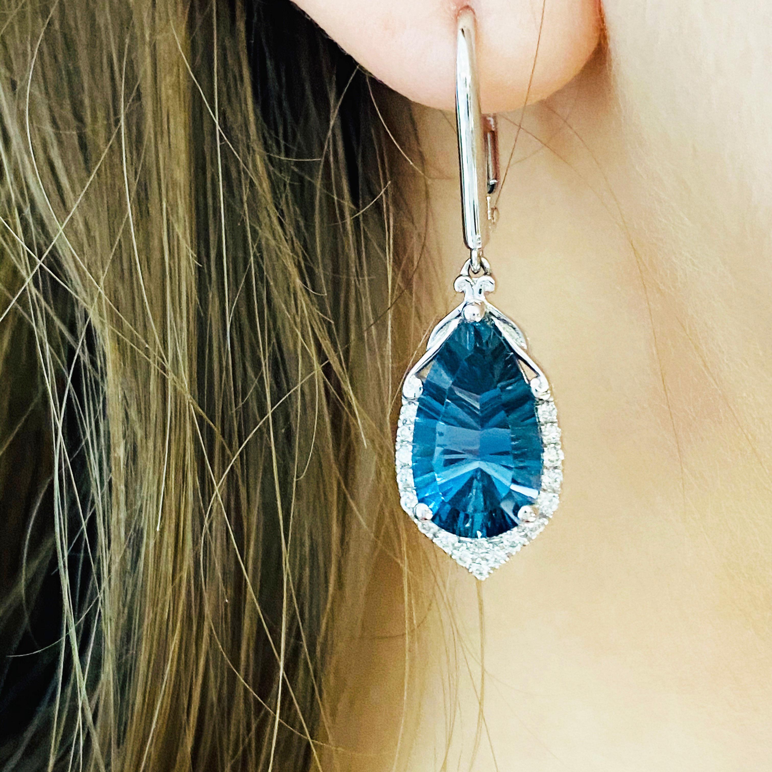 You won't believe how much these earrings sparkle! These gorgeous 14k white gold vibrant royal blue topaz dangle earrings dripping with 36 excellent white diamonds are absolutely stunning and sure to make anyone's heart skip a beat. The vibrant